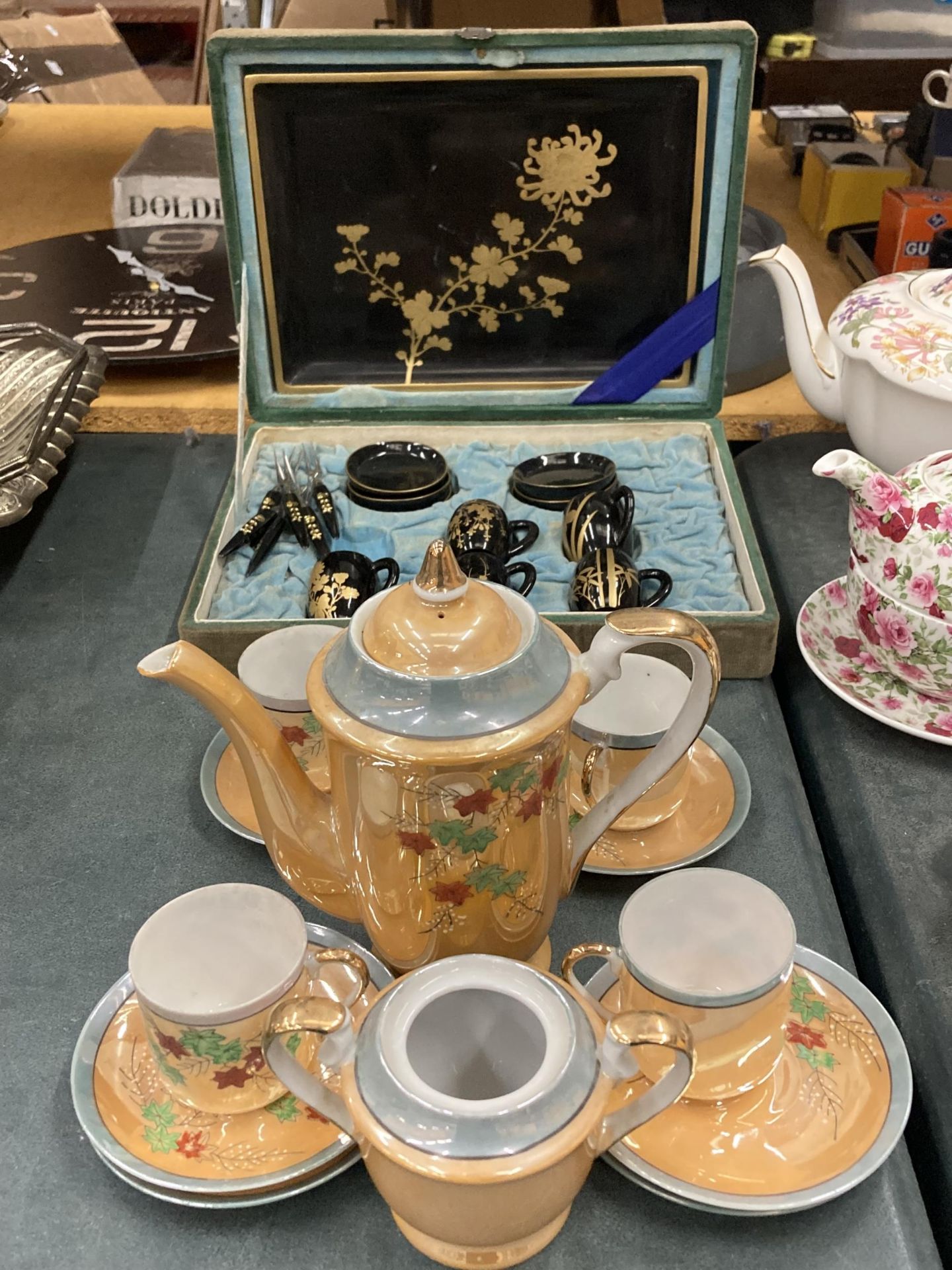 AN ORANGE LUSTRE COFFEE SET TO INCLUDE A COFFEE POT, SUGAR BASIN CUPS AND SAUCERS PLUS A SET OF