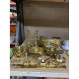 A LARGE QUANTITY OF BRASSWARE TO INCLUDE CANDLESTICKS, PLANTER, PANS, BELLS, ETC.,