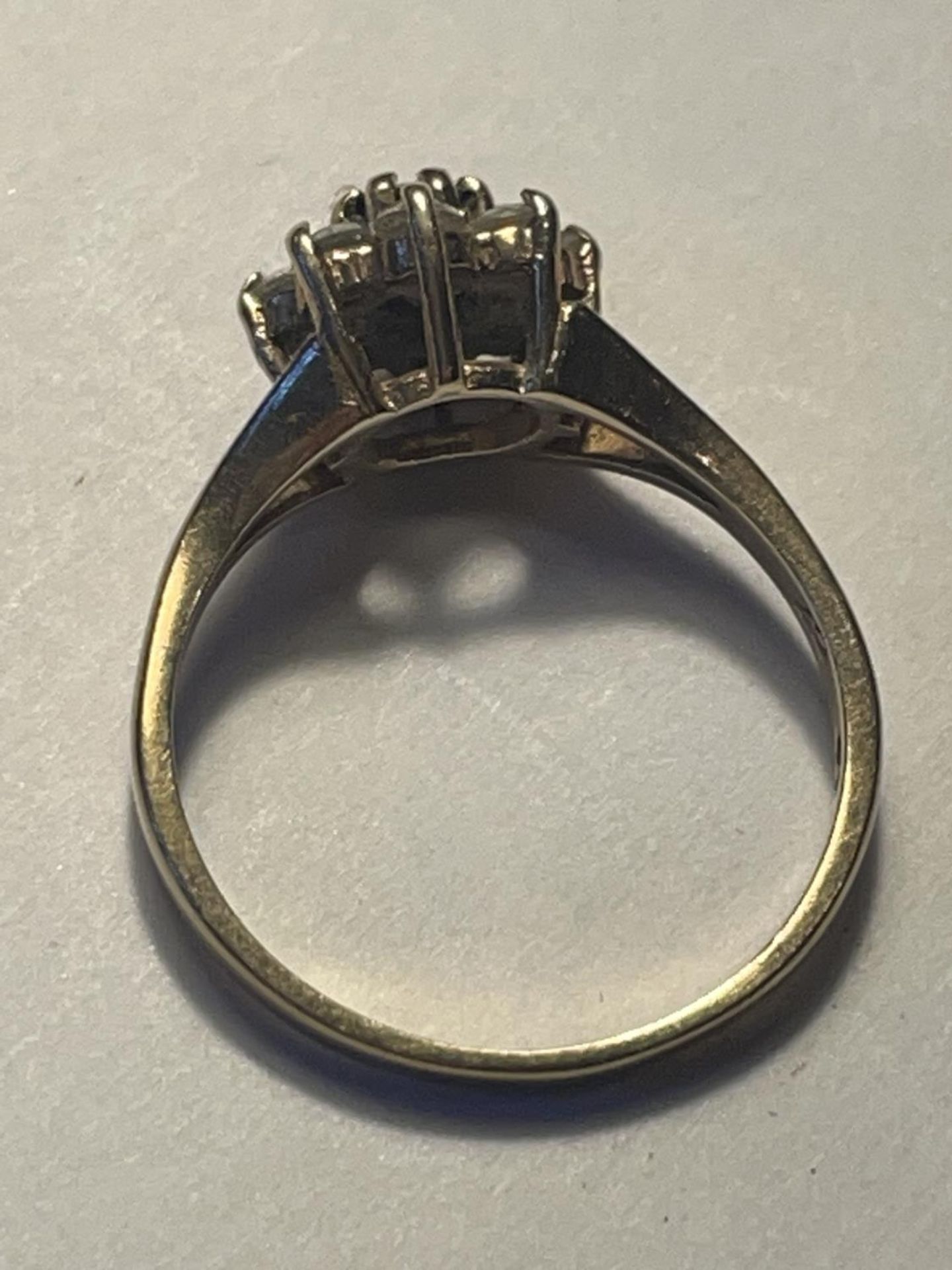 A 9 CARAT GOLD RING WITH A CENTRE SAPPHIRE SURROUNDED BY CUBIC ZIRCONIAS SIZE K/L - Image 3 of 3