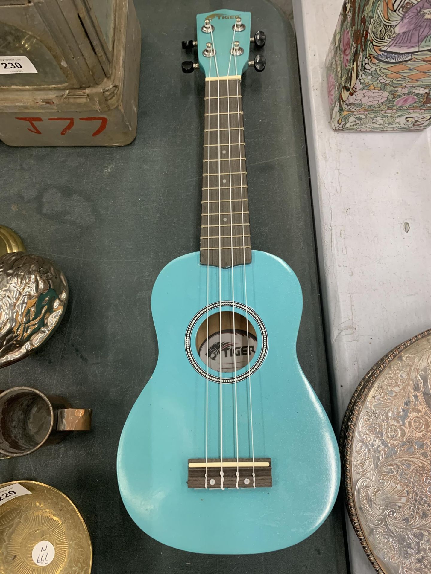 A 'TIGER' TURQUOISE COLOURED UKELELE