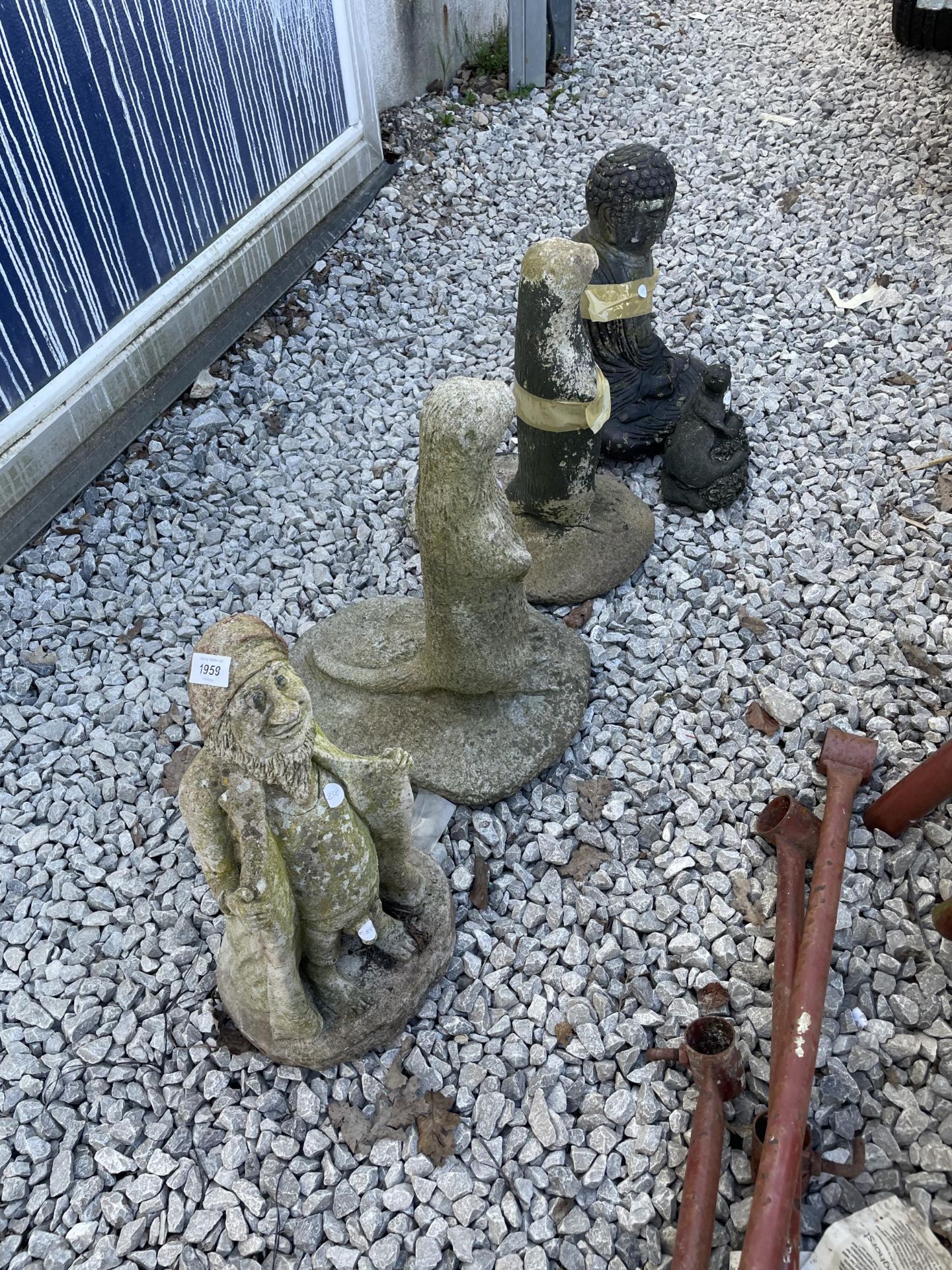 FIVE LARGE RECONSTITUTED STONE GARDEN FIGURES TO INCLUDE OTTERS AND A BUDDHA ETC