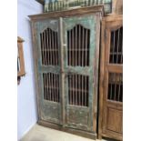 A VINTAGE INDIAN HARDWOOD OPENWORK TWO DOOR CABINET WITH BRASS HASP + IRON BAR, 48" WIDE