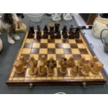 A FOLDING CHESS BOARD WITH CHESS PIECES