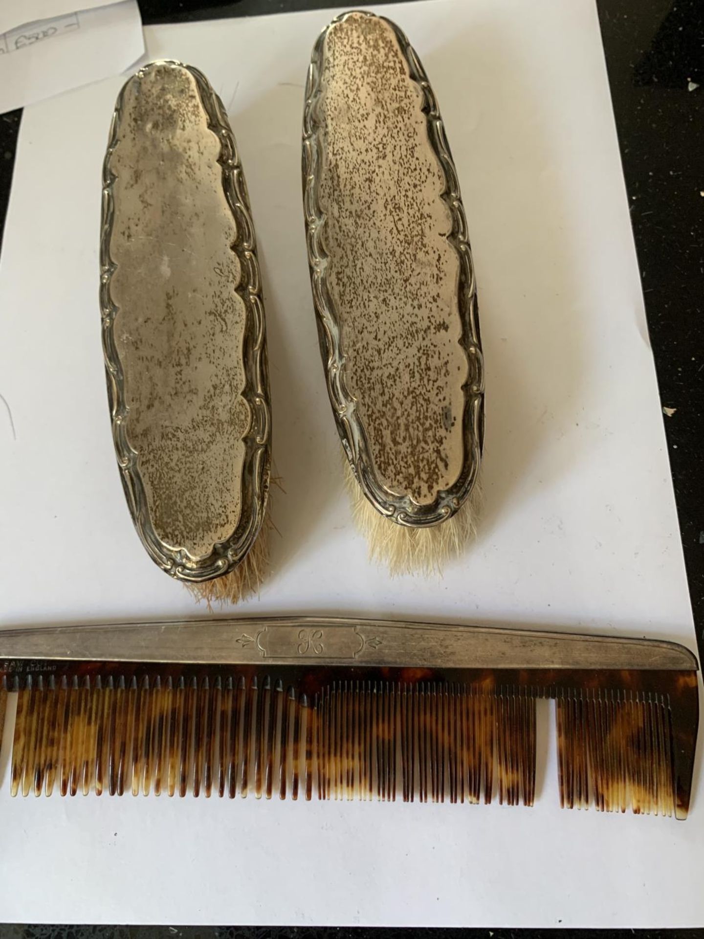 TWO HALLMARKED BIRMINGHAM SILVER BACKED BRUSHES AND A STERLING SILVER COMB