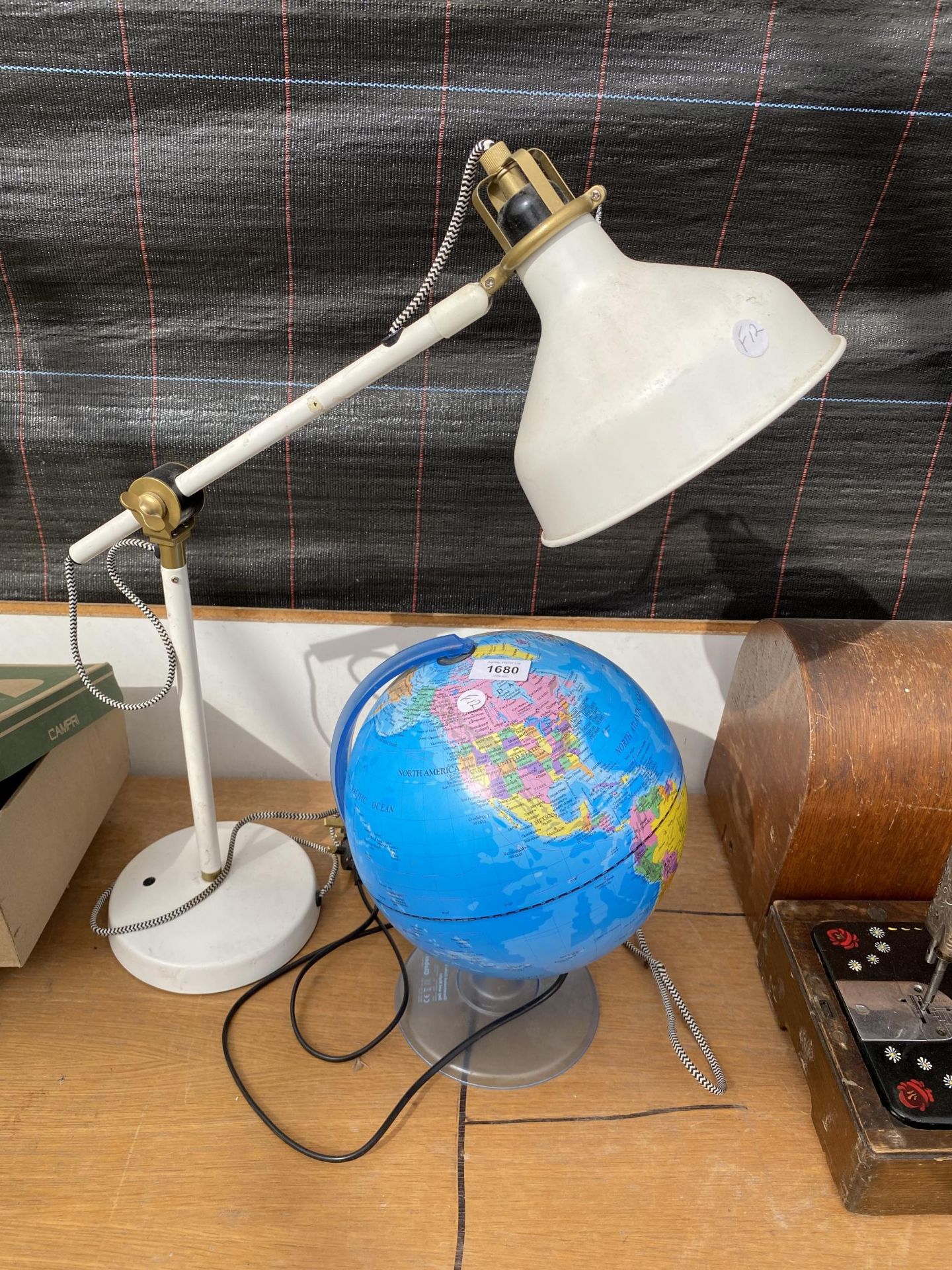 A LIGHT UP GLOBE AND A FURTHER ADJUSTABLE TABLE LAMP
