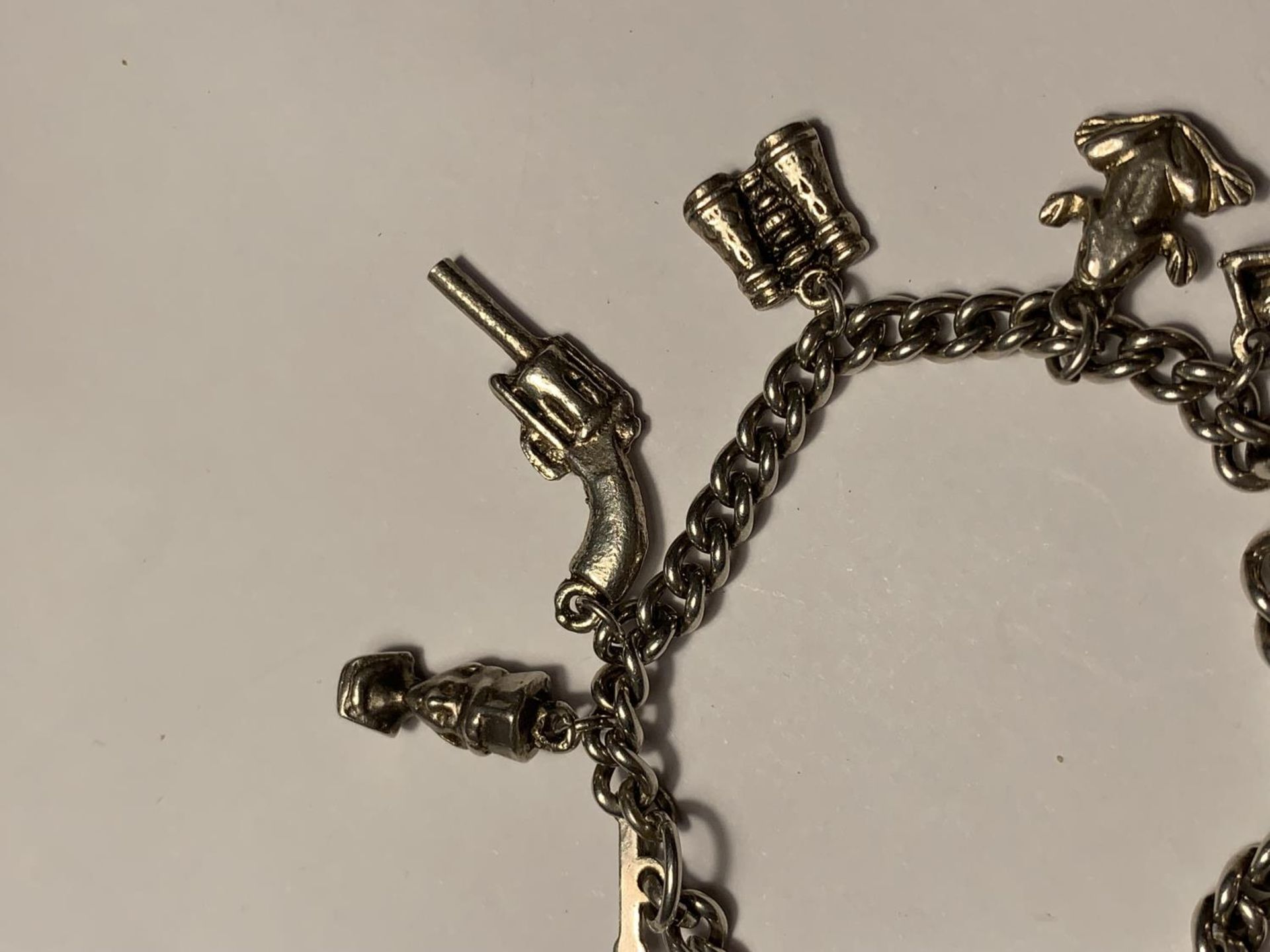 A SILVER CHARM BRACELET WITH ELEVEN VARIOUS CHARMS - Image 3 of 4
