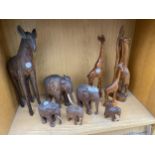 AN ASSORTMENT OF WOODEN ANIMAL FIGURES TO INCLUDE ELEPHANTS AND GIRAFFES ETC