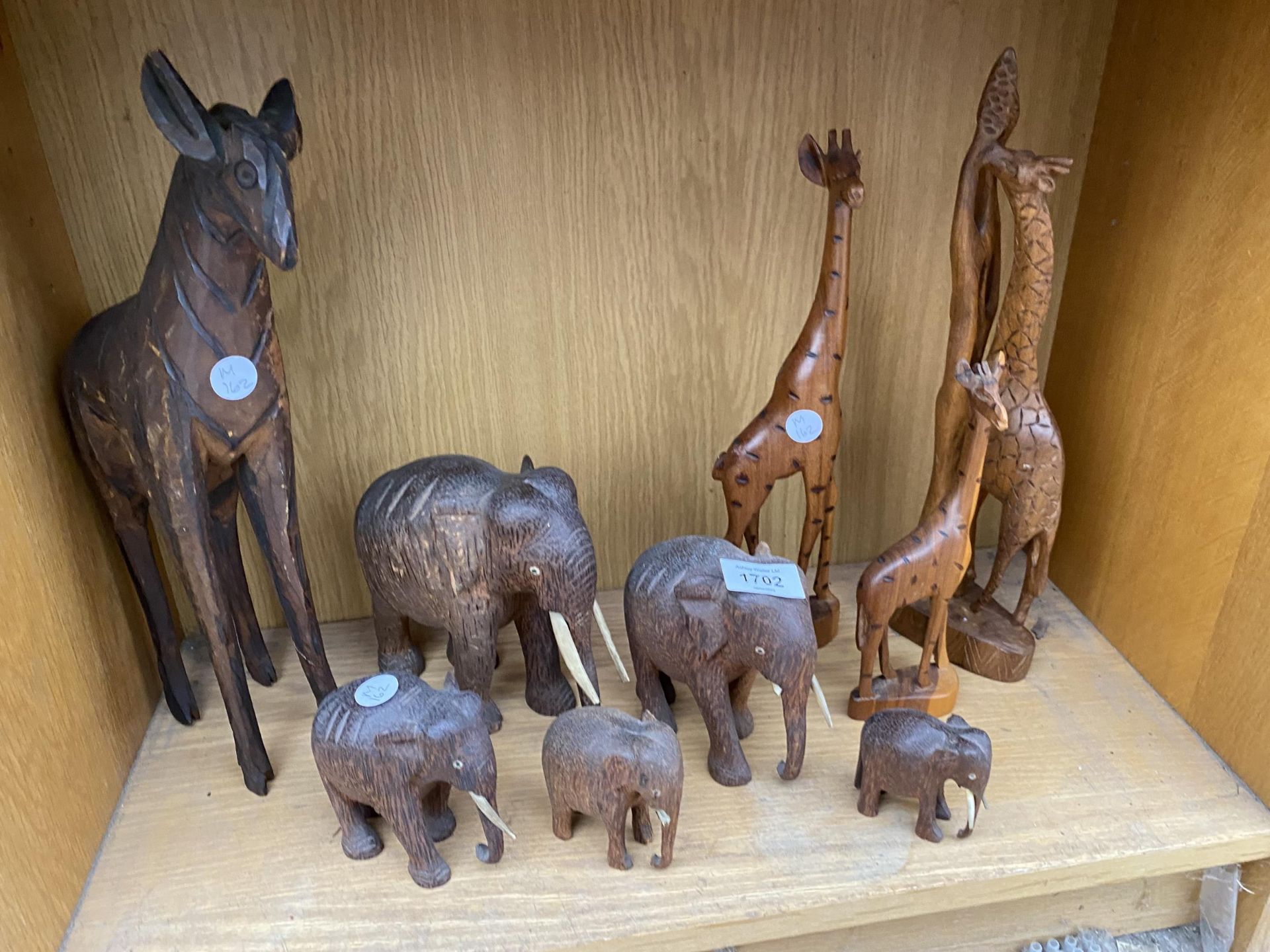 AN ASSORTMENT OF WOODEN ANIMAL FIGURES TO INCLUDE ELEPHANTS AND GIRAFFES ETC