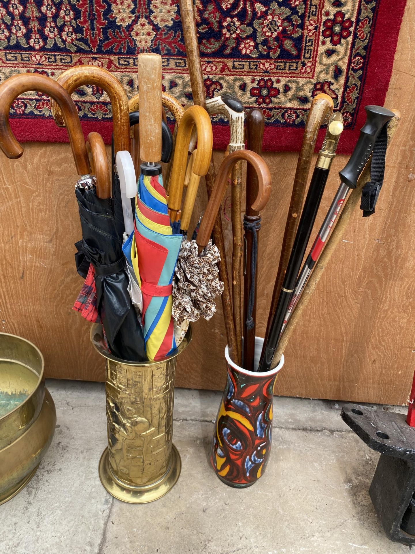 A BRASS STICK STAND AND A CERAMIC STICK STAND BOTH CONTAINING A LARGE QUANTITY OF WALKING STICKS AND - Image 2 of 3