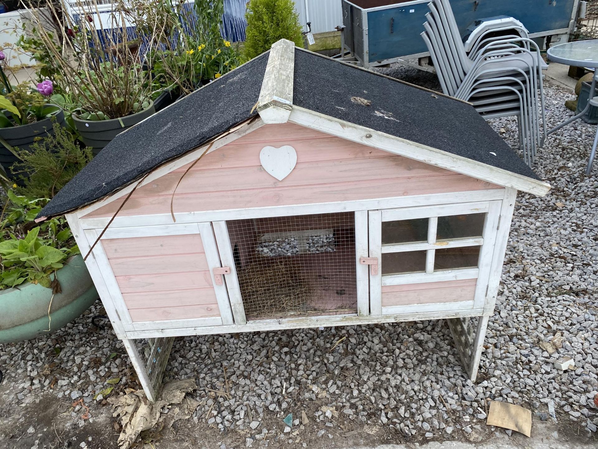 A WOODEN TWO TIER RABBIT HUTCH