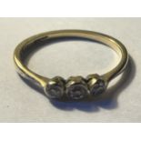 AN 18 CARAT GOLD RING WITH THREE IN LINE DIAMONDS GROSS WEIGHT 1.61 GRAMS SIZE L