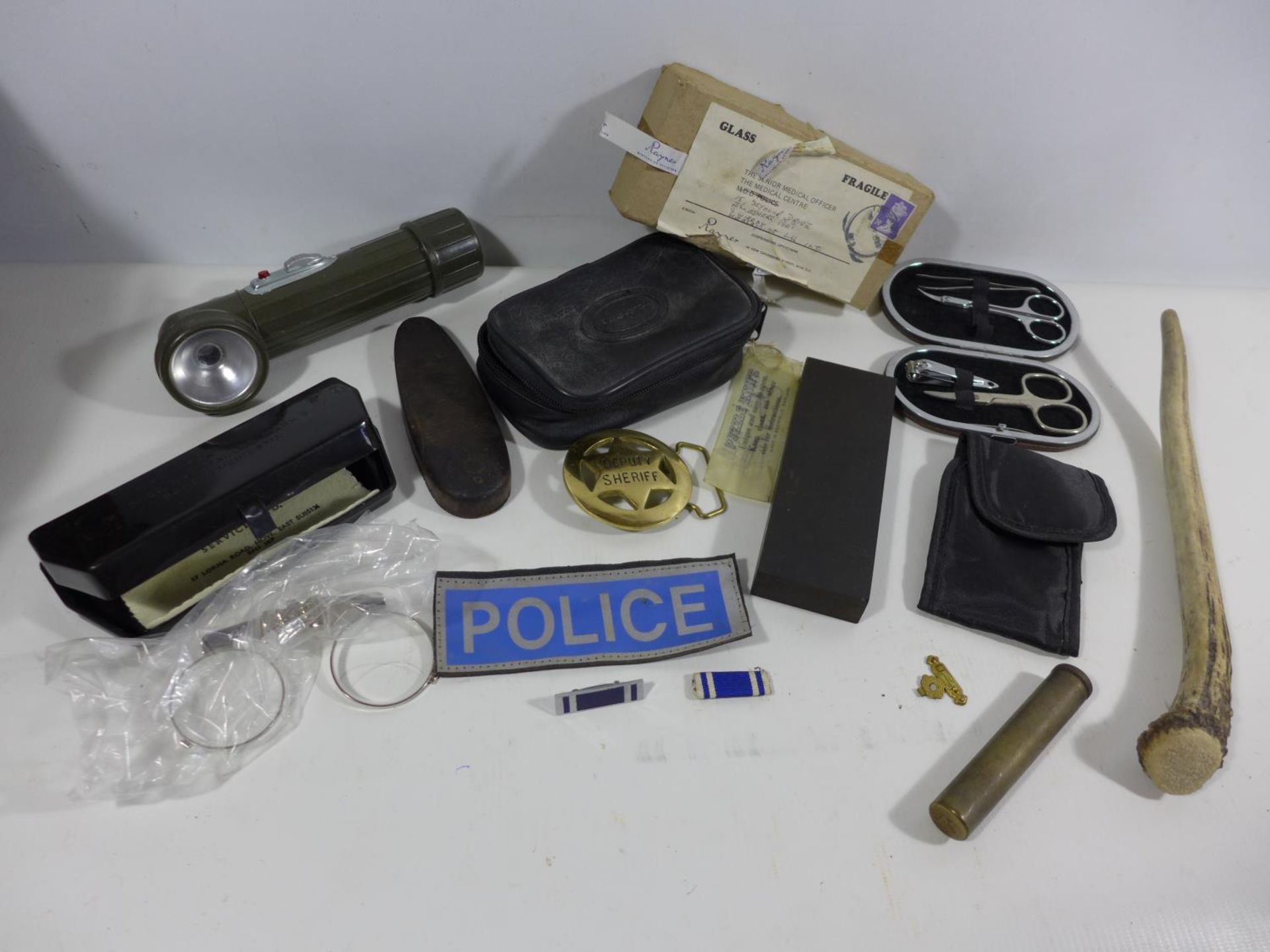 A POLICE BADGE, MILITARY MARK 5 SPECTACLES, OIL CONTAINER, TORCH ETC