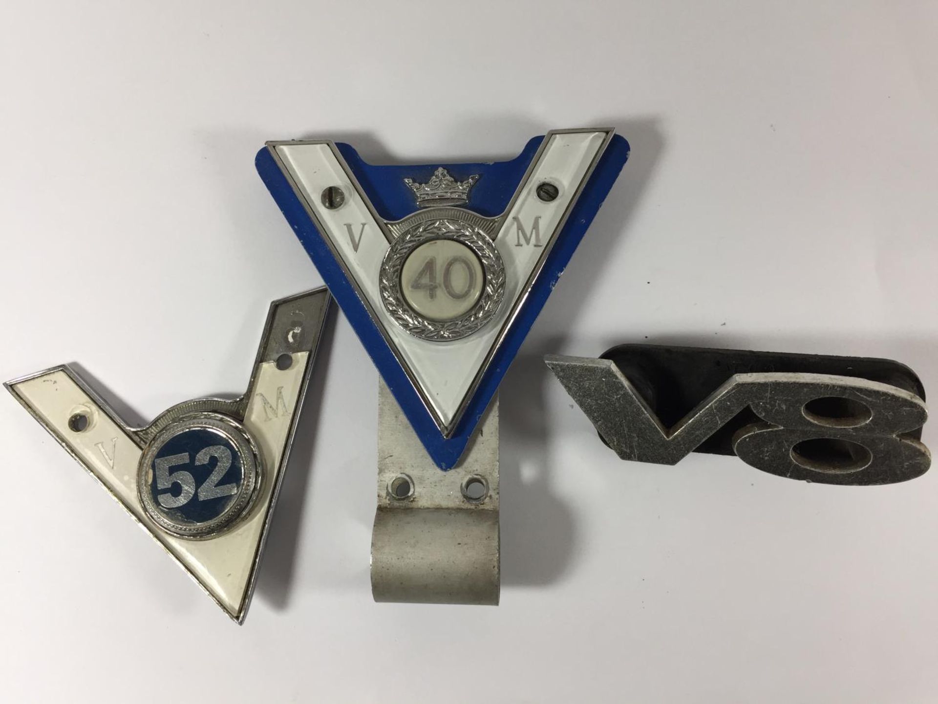 TWO VINTAGE VETERAN MOTOR CLUB BADGES 40 YEARS AND 52 YEARS AND A V8 LOGO