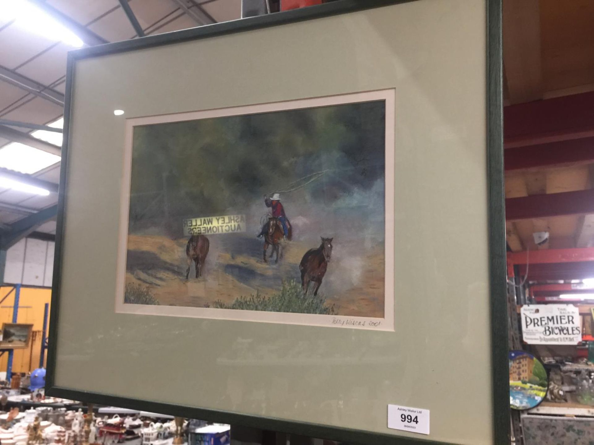 A FRAMED AND MOUNTED SIGNED PRINT 2001 BY POLLY WISCUS ARTIST OF COWBOY AND HORSES SCENE
