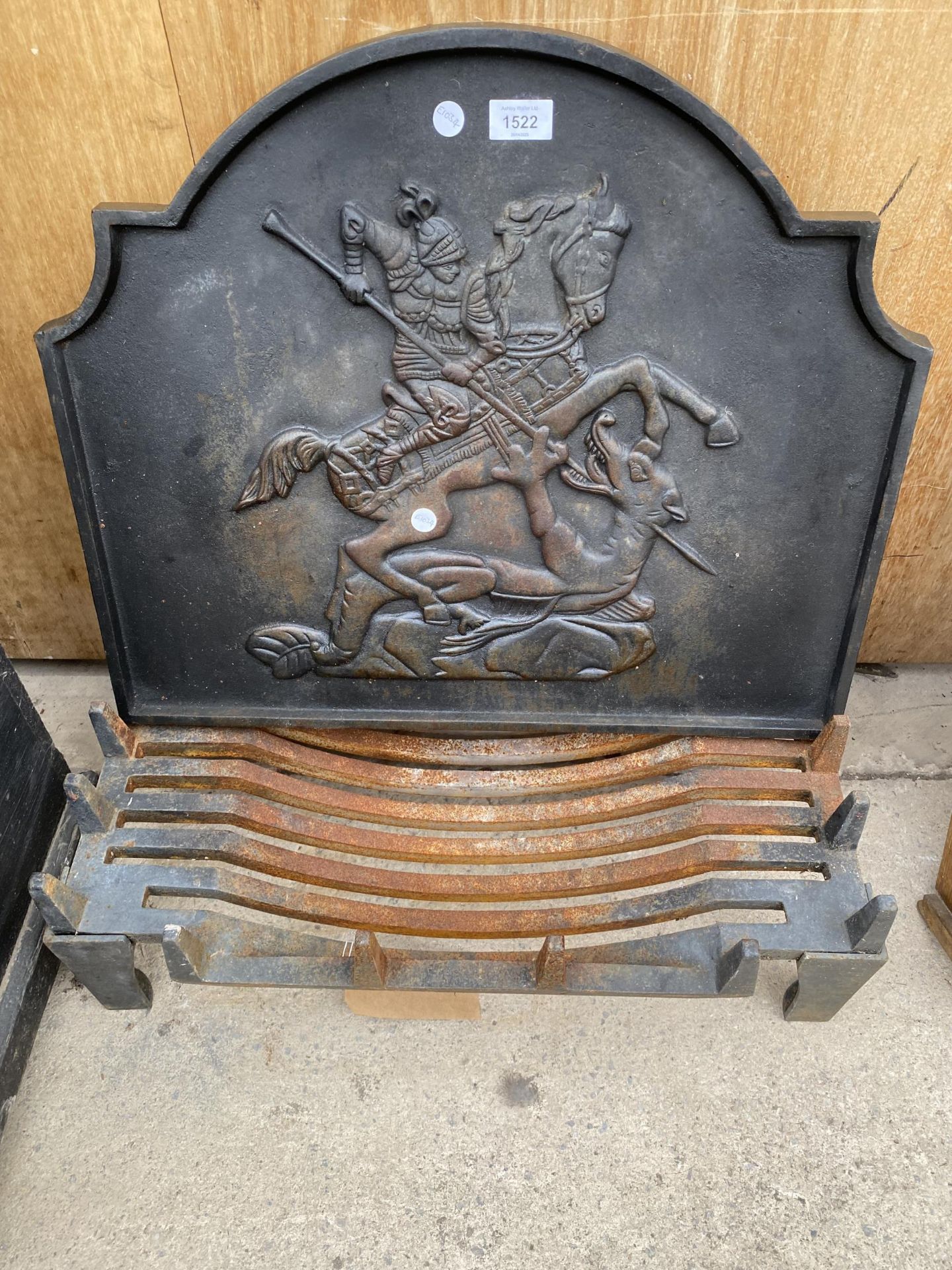 A LARGE FIRE GRATE AND A DECORATIVE CAST IRON FIRE BACK