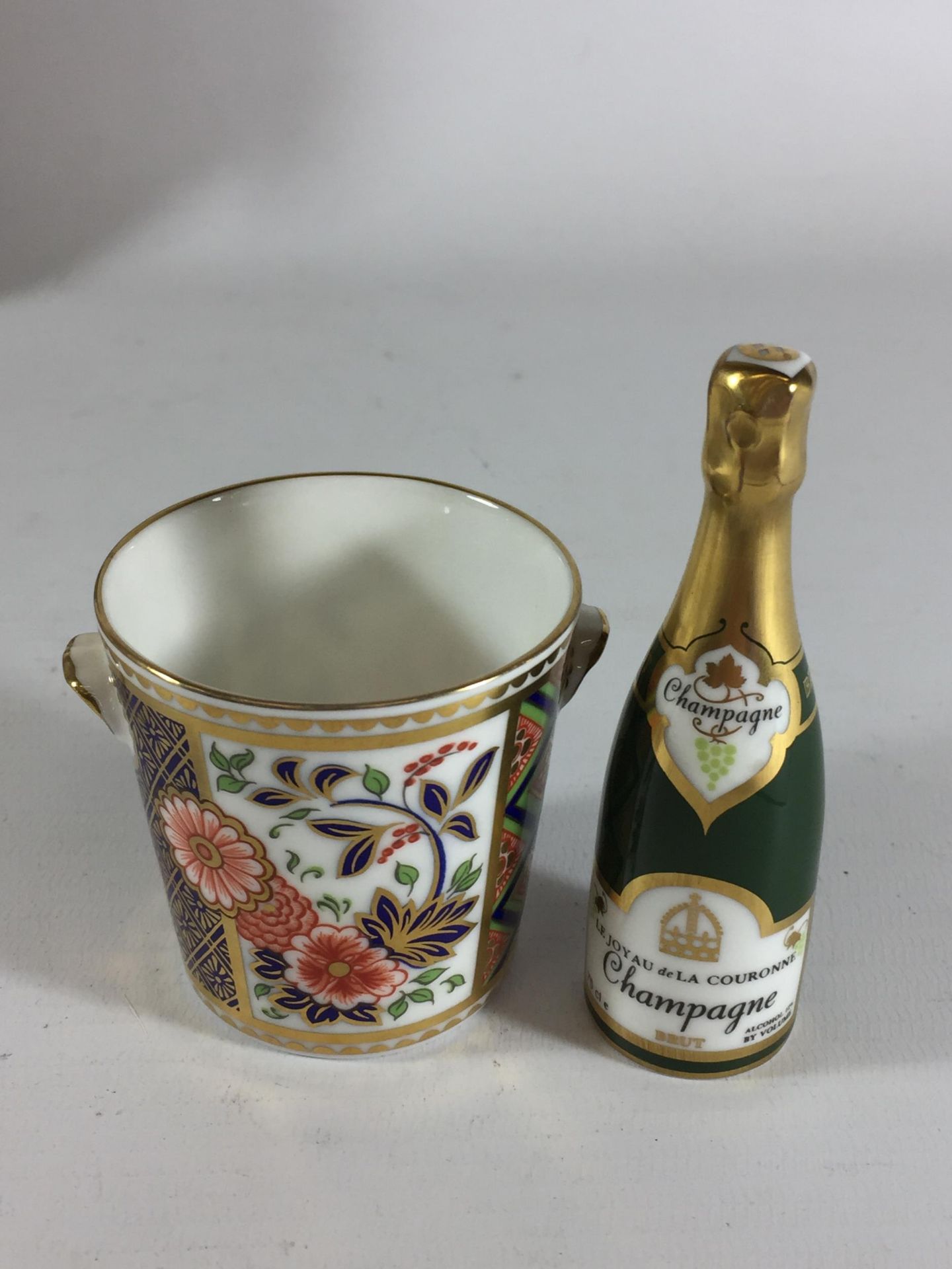 TWO ROYAL CROWN DERBY ITEMS - A MINIATURE CHAMPAGNE BOTTLE AND COOLER