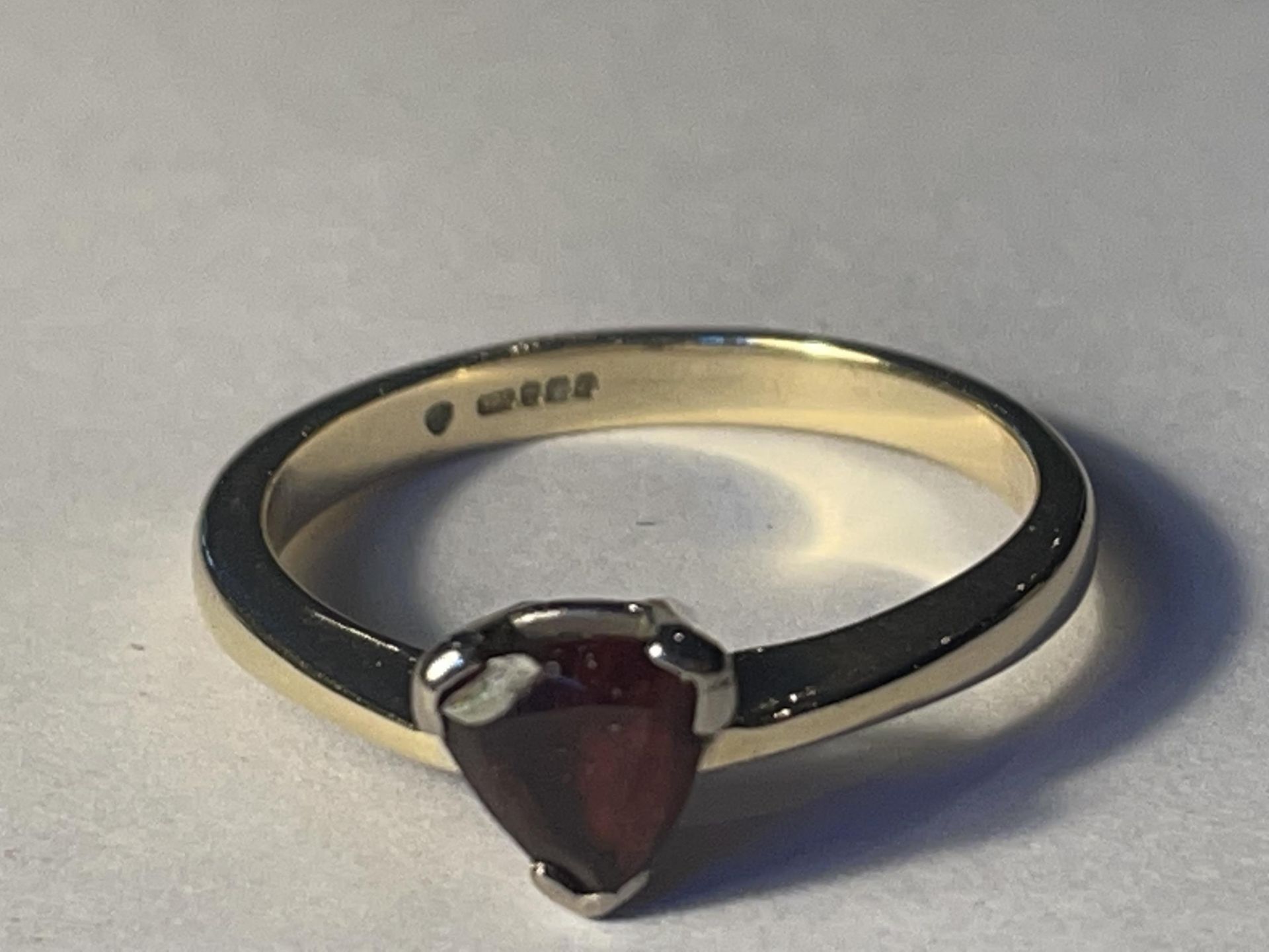 A 9 CARAT GOLD RING WITH A HEART SHAPED RUBY GROSS WEIGHT 3.27 GRAMS SIZE Q/R