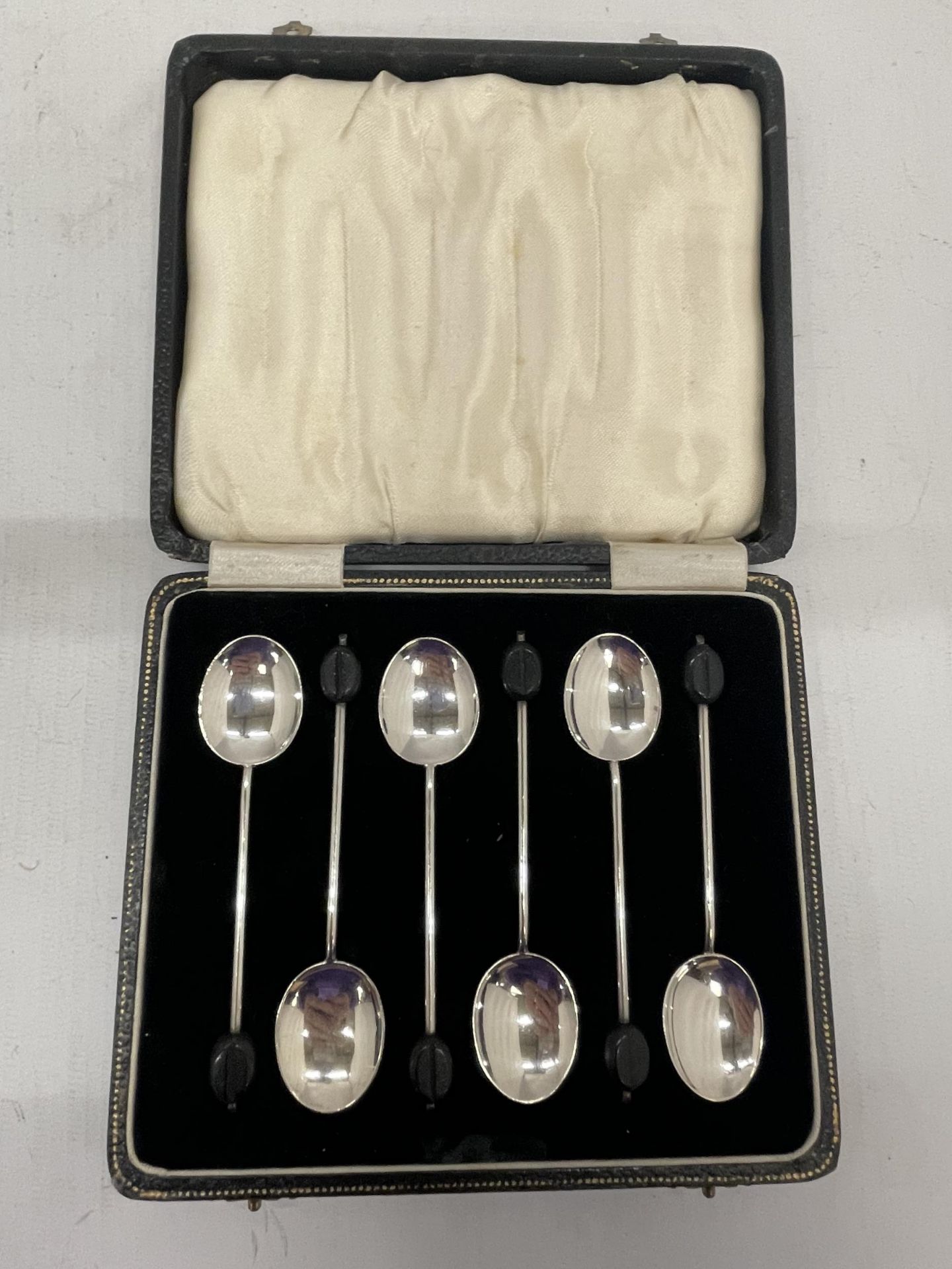 A CASED SET OF SIX HALLMARKED SILVER COFFEE BEAN SPOONS