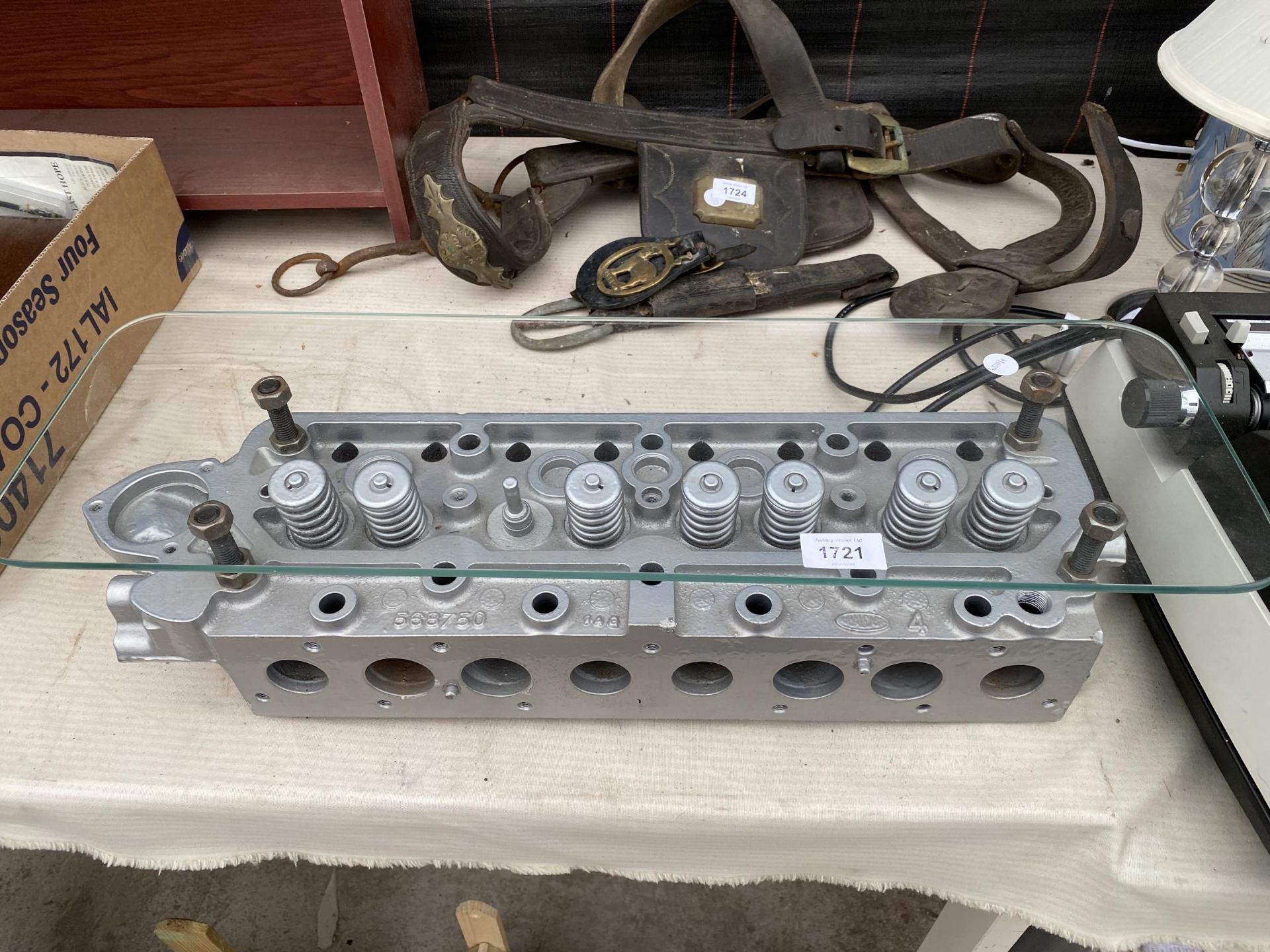 A GLASS SHELF MADE USING A CYLINDER HEAD