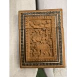 A WOODEN CARVED CARD CASE