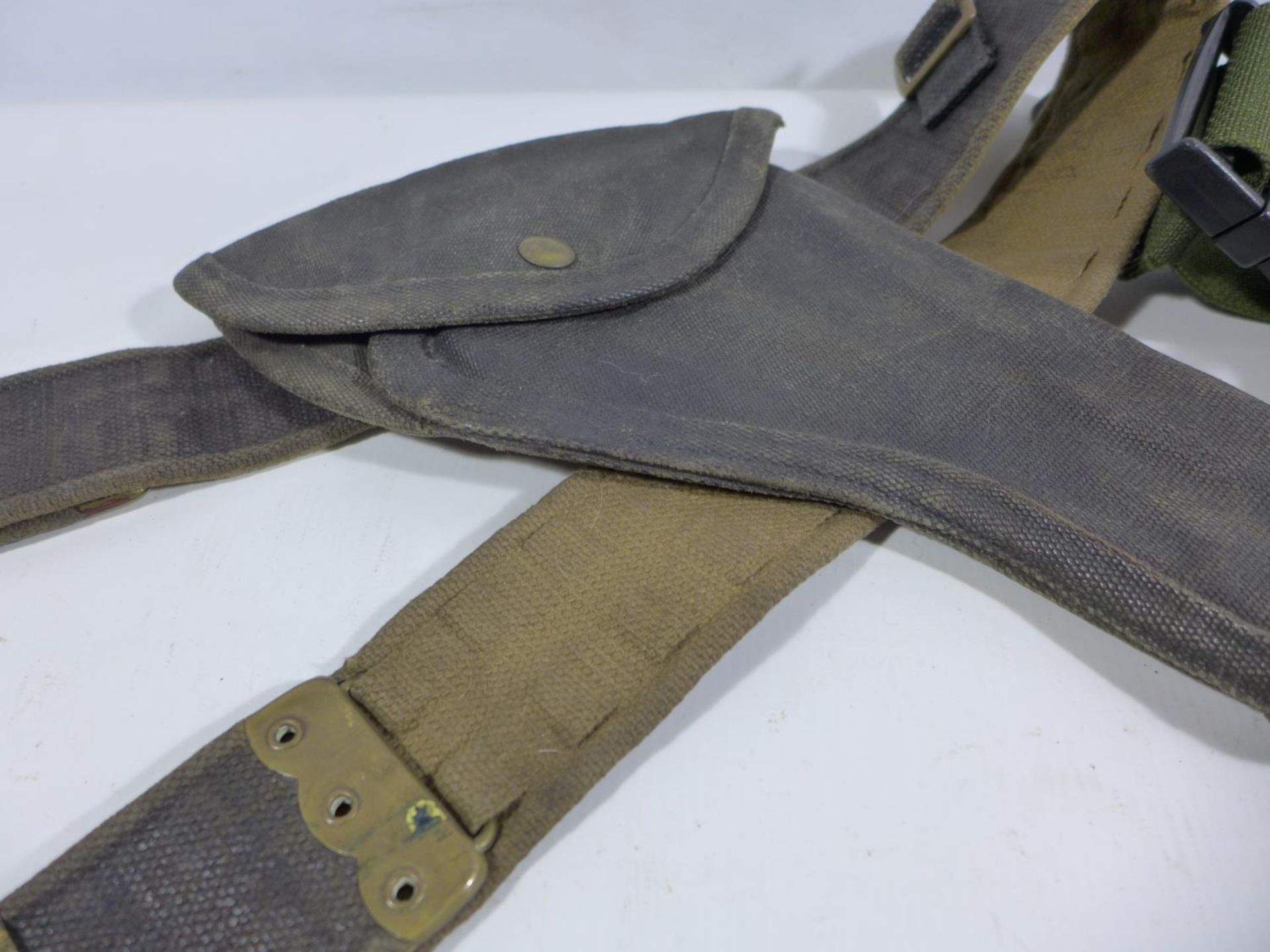 A MILITARY ISSUE CANVAS BELT AND HOLSTER AND A CAMOUFLAGE BELT PACK (2) - Image 2 of 4