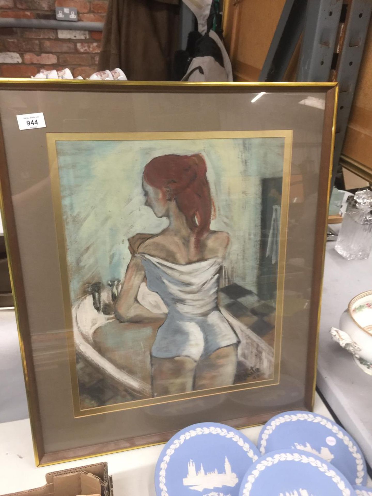 A FRAMED PRINT OF A GIRL PREPARING TO BATHE