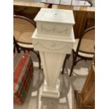 A 19TH CENTURY STYLE WHITE PAINTED TAPERING PEDESTAL DECORATED WITH SWAGS