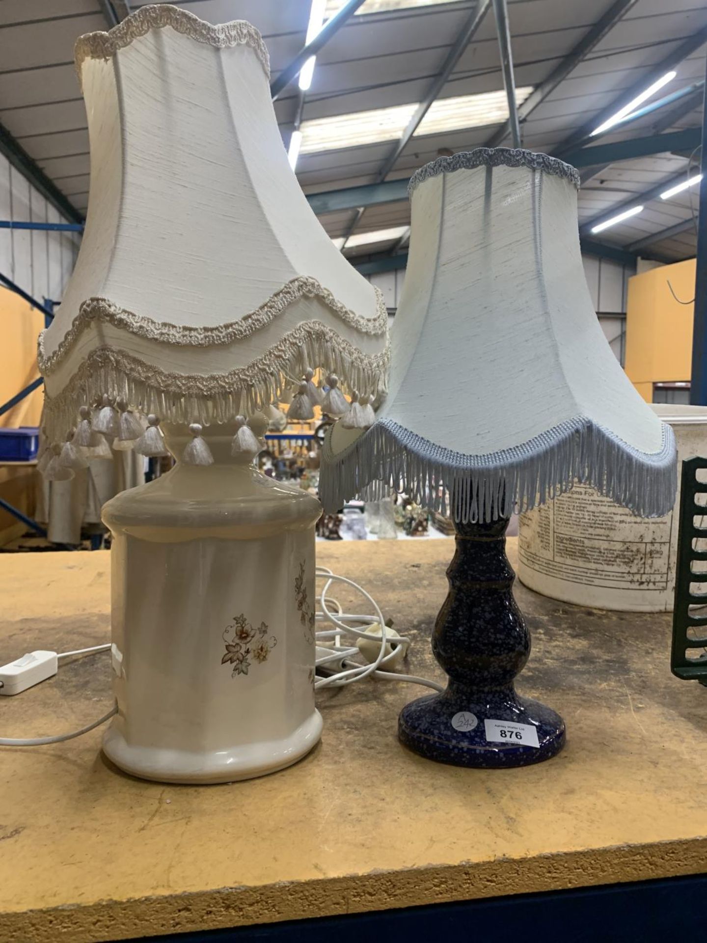 TWO TABLE LAMPS WITH SHADES, ONE A MOTTLED BLUE COLOUR, THE OTHER FLORAL PATTERNED