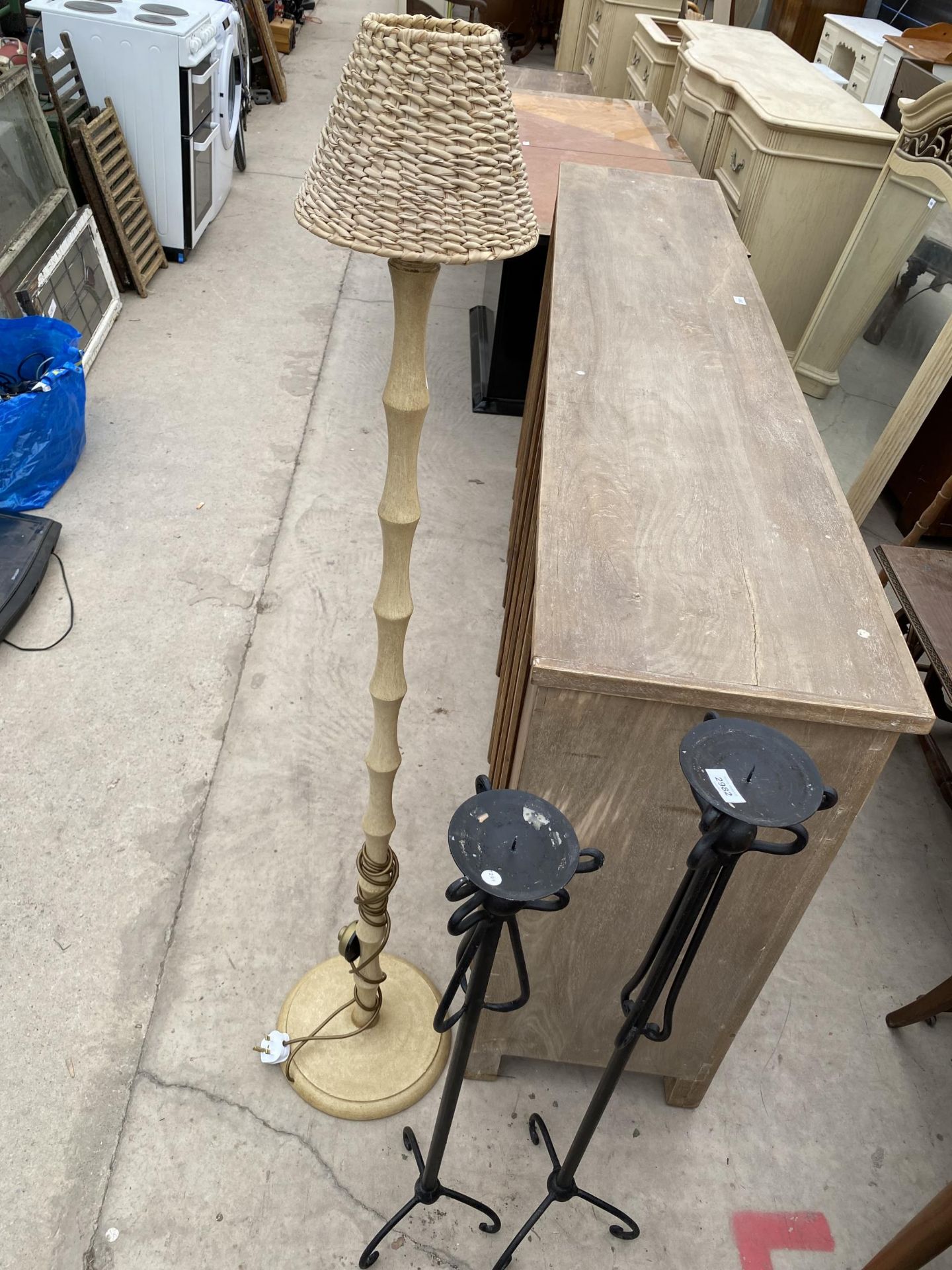 TWO WROUGHT IRON CANDLESTANDS AND TURNED COLUMN STANDARD LAMP