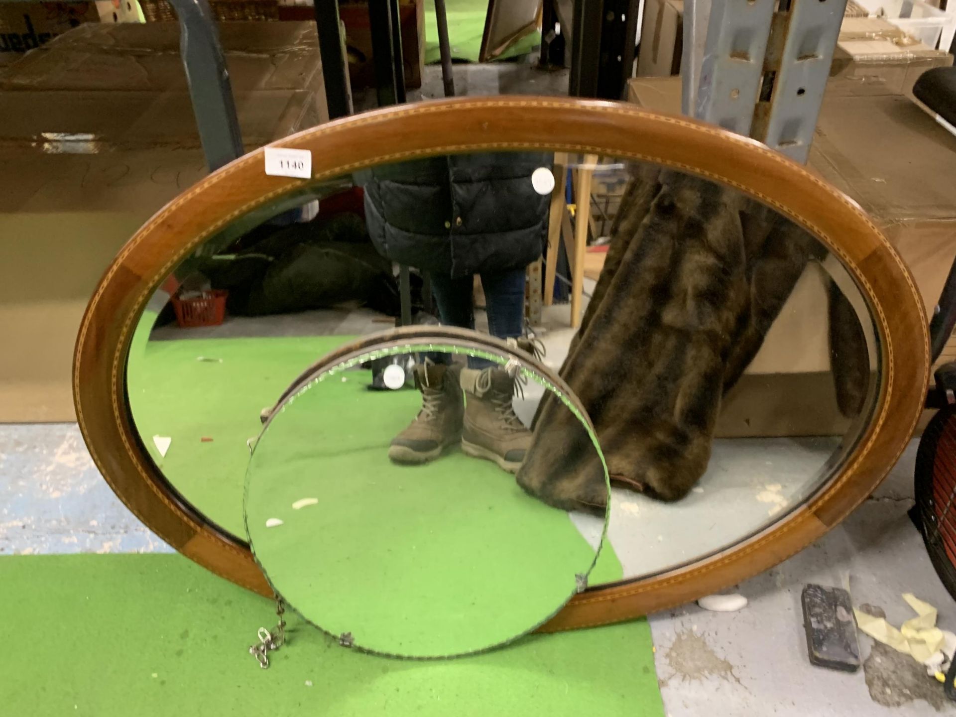 TWO VINTAGE MIRRORS TO INCLUDE AN UNFRAMED ROUND ONE PLUS A MAHOGANY SURROUND OVAL ONE WITH INLAY