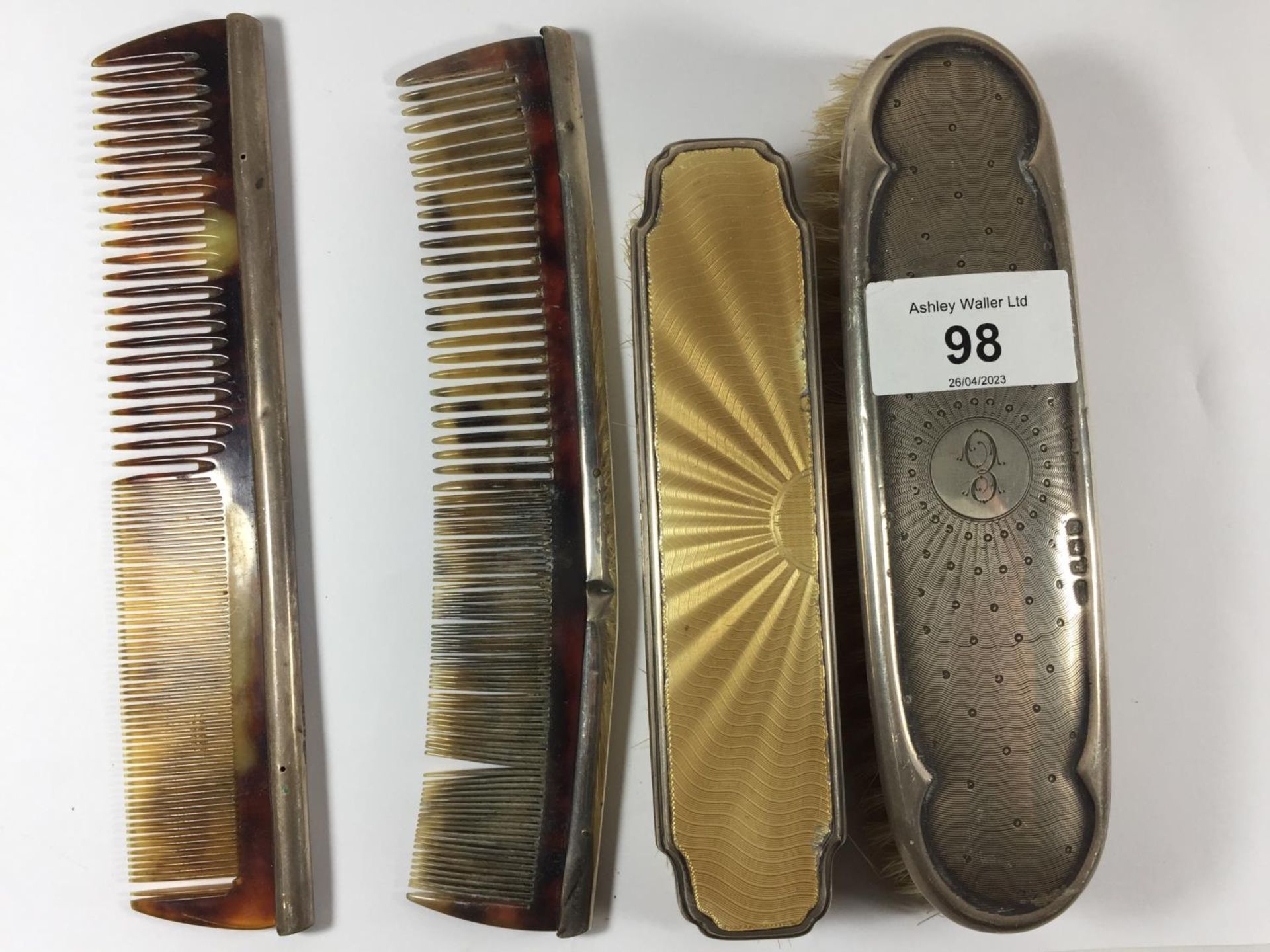 FOUR SILVER ITEMS TO INCLUDE TWO BRUSHES AND TWO COMBS