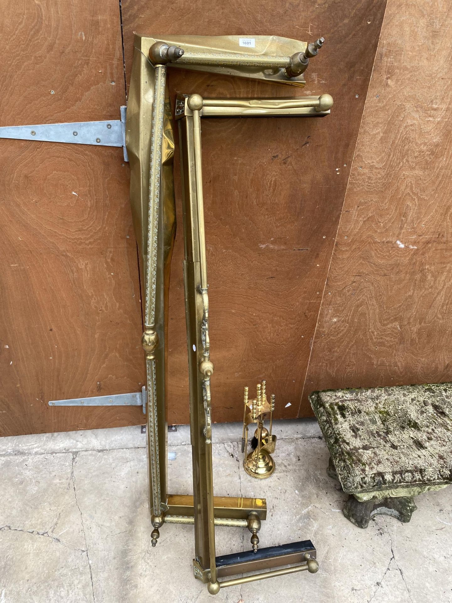 TWO BRASS FIRE FENDERS AND A BRASS FIRE SIDE COMPANION SET