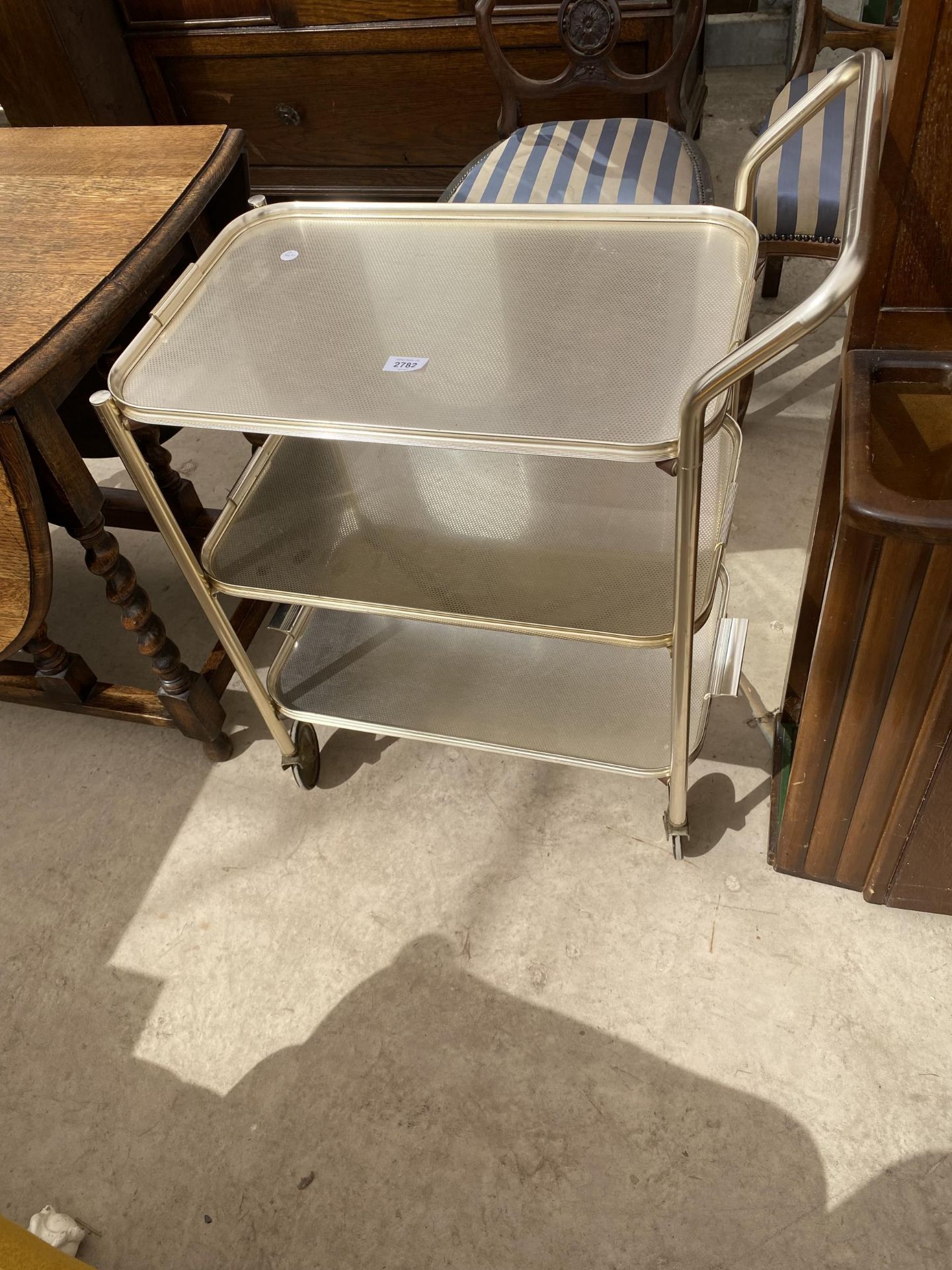 A 1970'S THREE TIER METALWARE TROLLEY WITH THREE DETACHABLE TRAYS