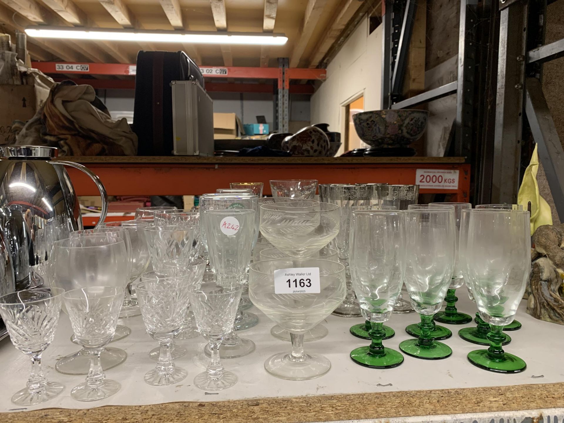 A QUANTITY OF GLASSES TO INCLUDE CHAMPAGNE FLUTES, SHERRY, PORT, DESSERT BOWLS, ETC