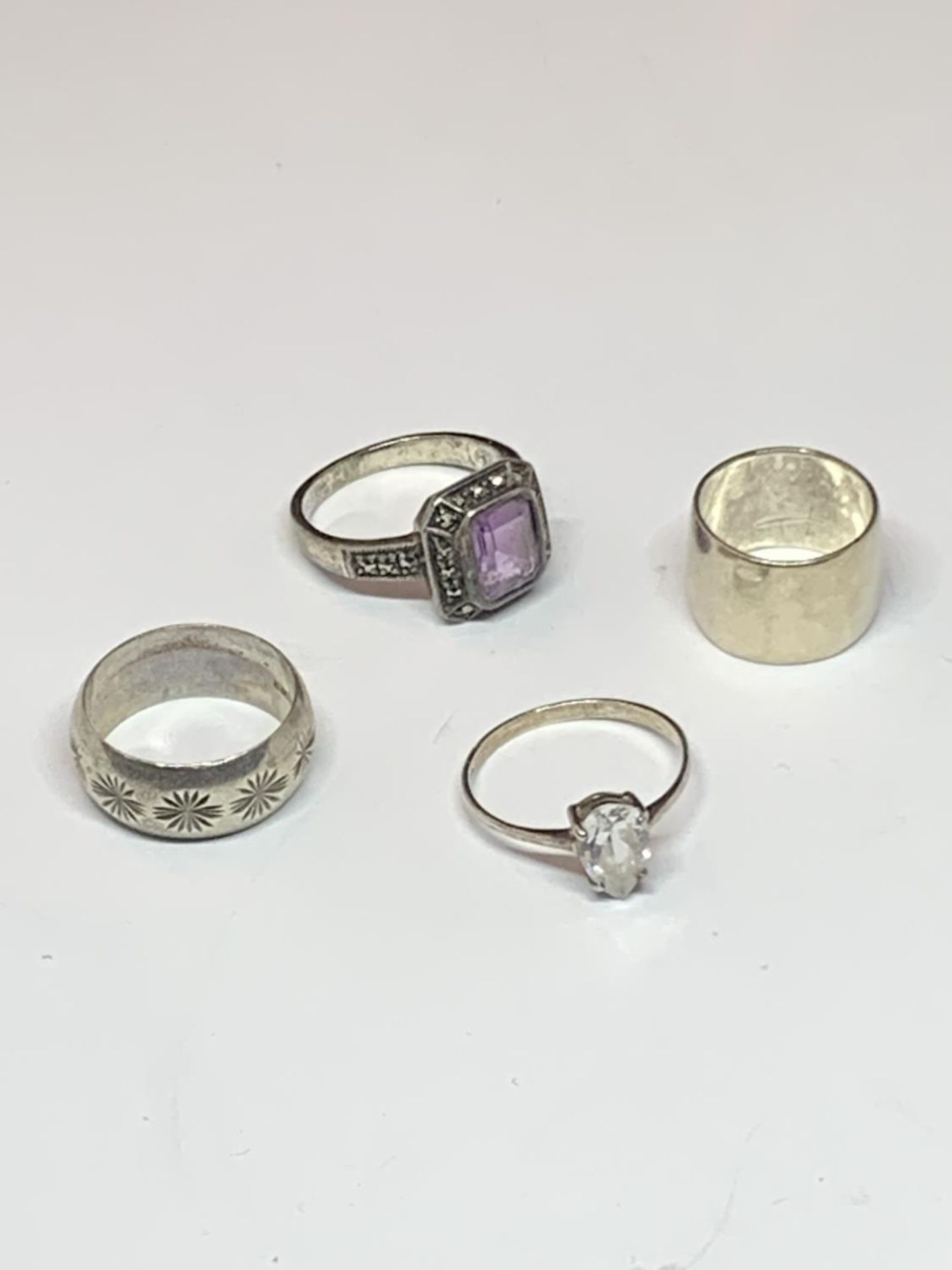 FOUR VARIOUS SILVER RINGS