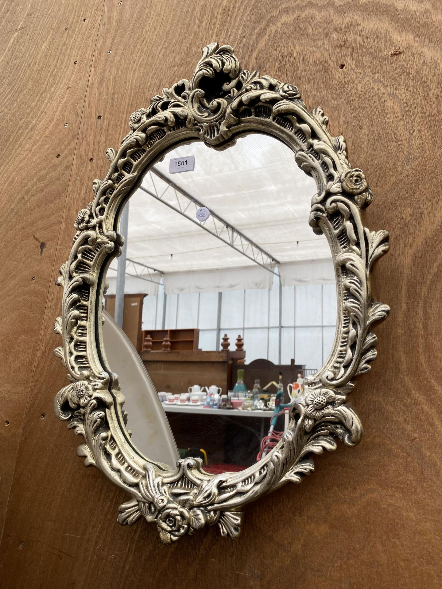 A DECORATIVE FLORAL FRAMED MIRROR