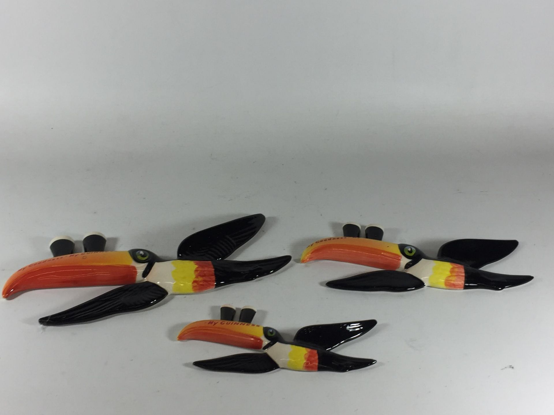 A SET OF THREE CARLTON WARE GUINESS TOUCANS