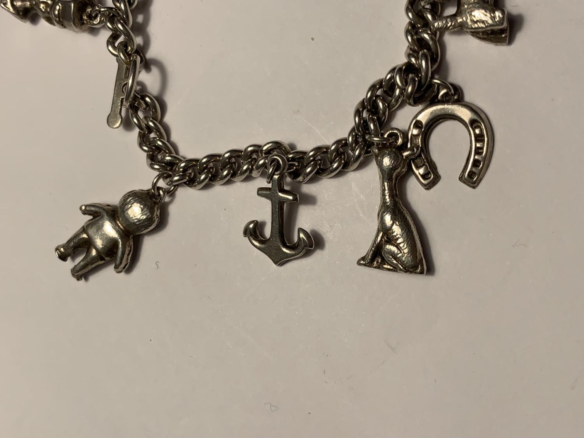 A SILVER CHARM BRACELET WITH ELEVEN VARIOUS CHARMS - Image 2 of 4