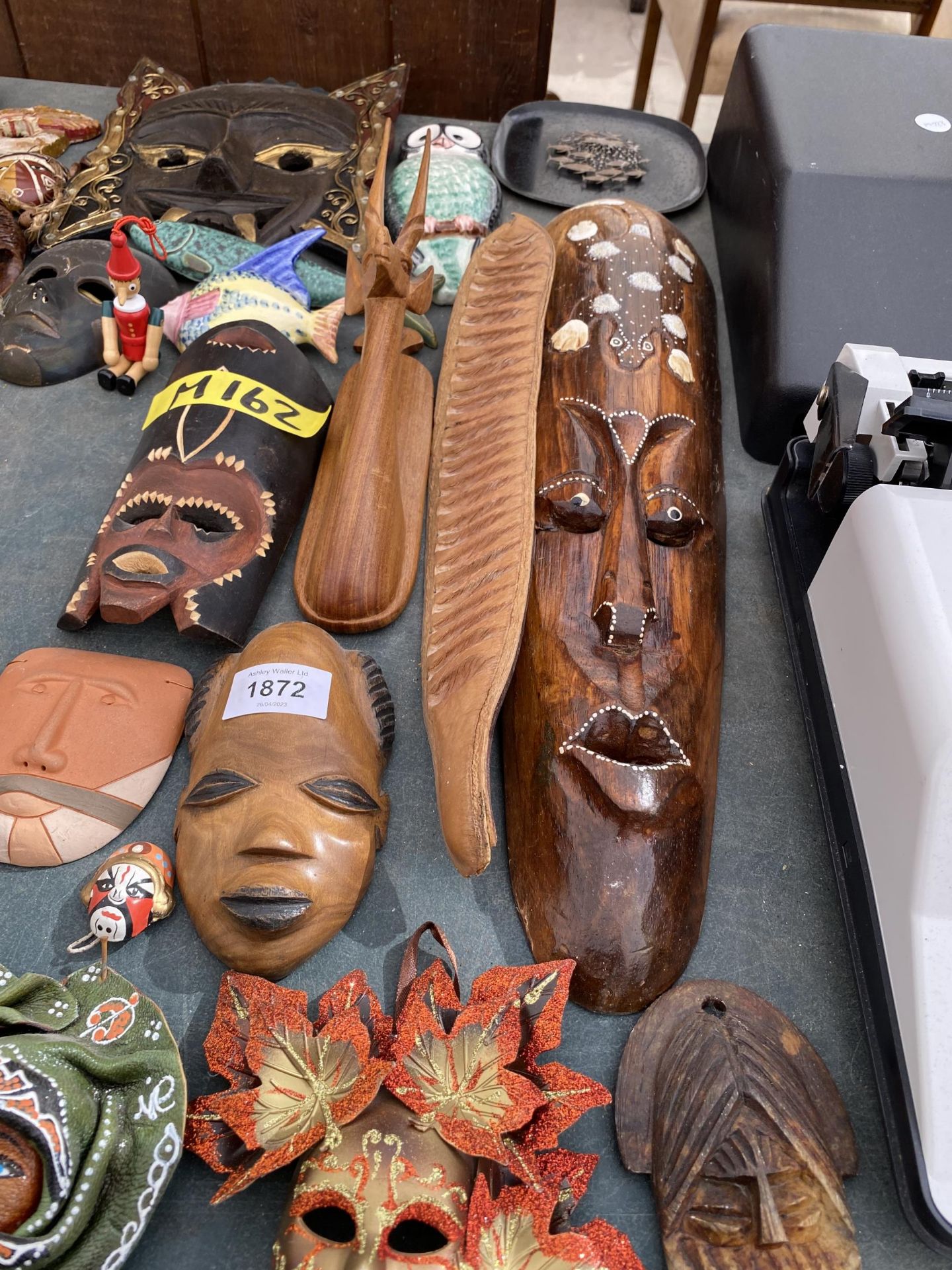 A LARGE QUANTITY OF TREEN CARVED TRIBAL MASKS