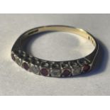 A 9 CARAT GOLD RING WITH FIVE CLEAR STONES AND FOUR REDSTONES IN A LINE GROSS WEIGHT 1.35 GRAMS SIZE