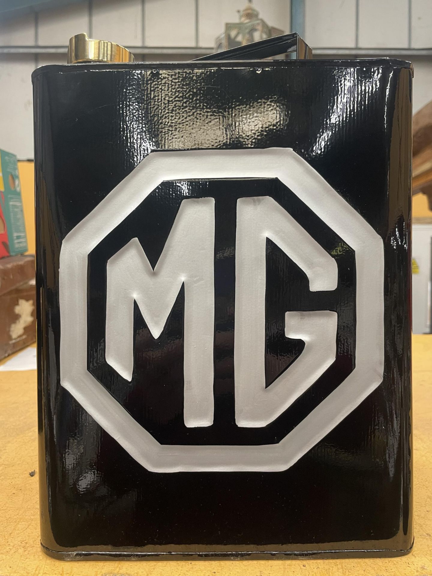A BLACK MG PETROL CAN WITH BRASS TOP