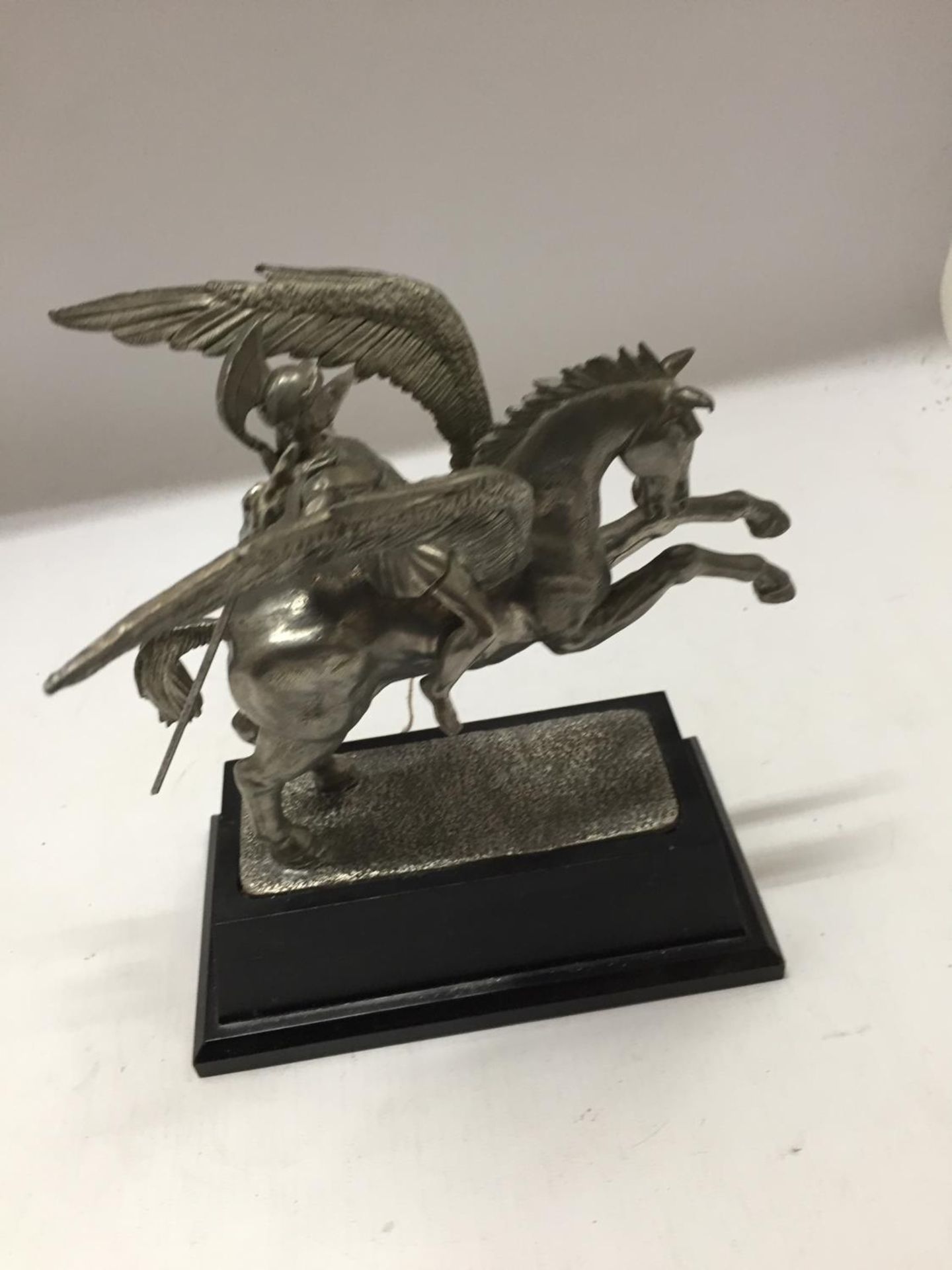 A WHITE METAL MODEL OF PEGASUS BEING RIDDEN BY PERSEUS, MOUNTED ON A BLACK WOODEN BASE,HEIGHT - Image 4 of 4