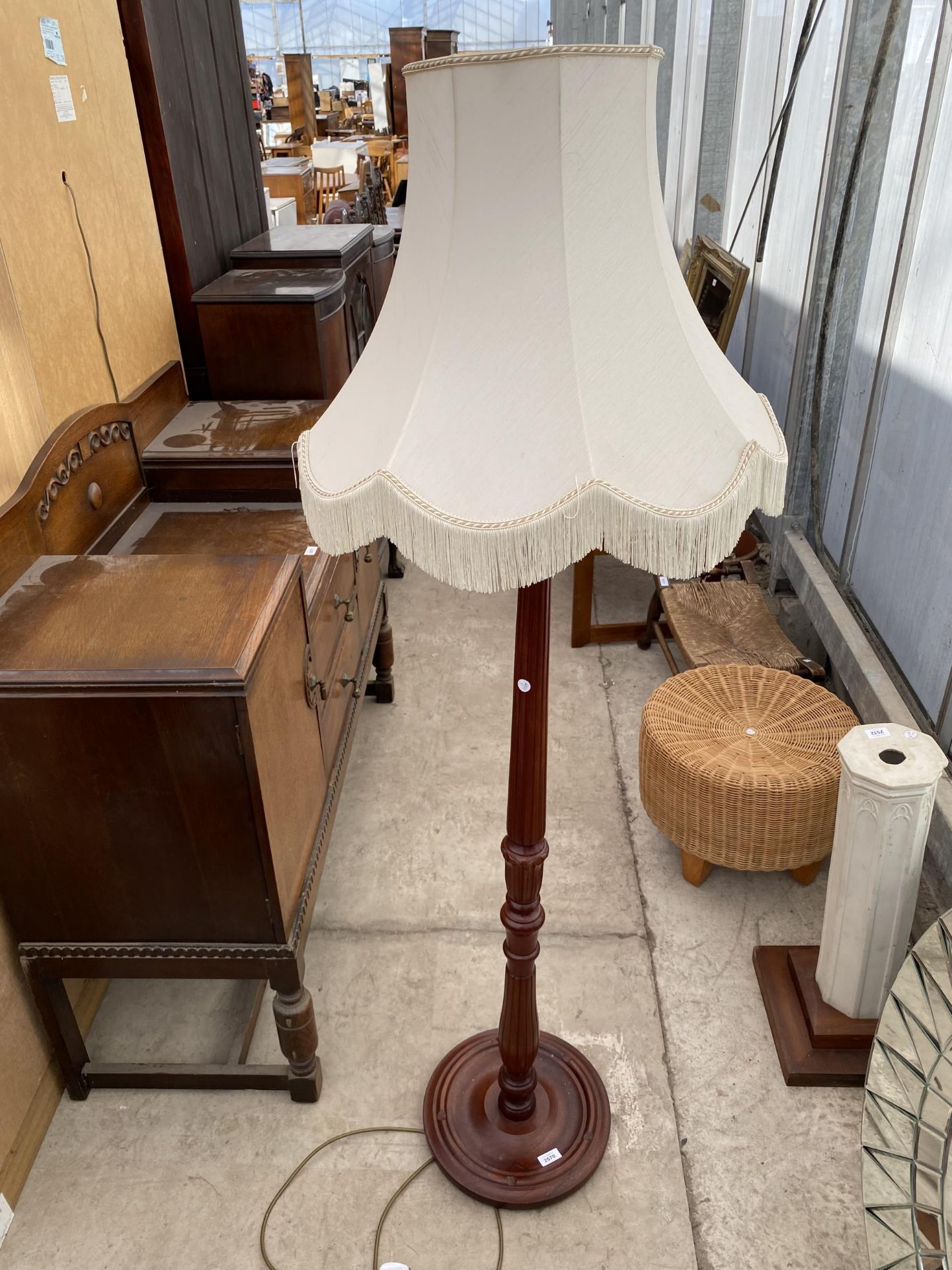 A MODERN STANDARD LAMP COMPLETE WITH SHADE ON TURNED AND FLUTED COLUMN