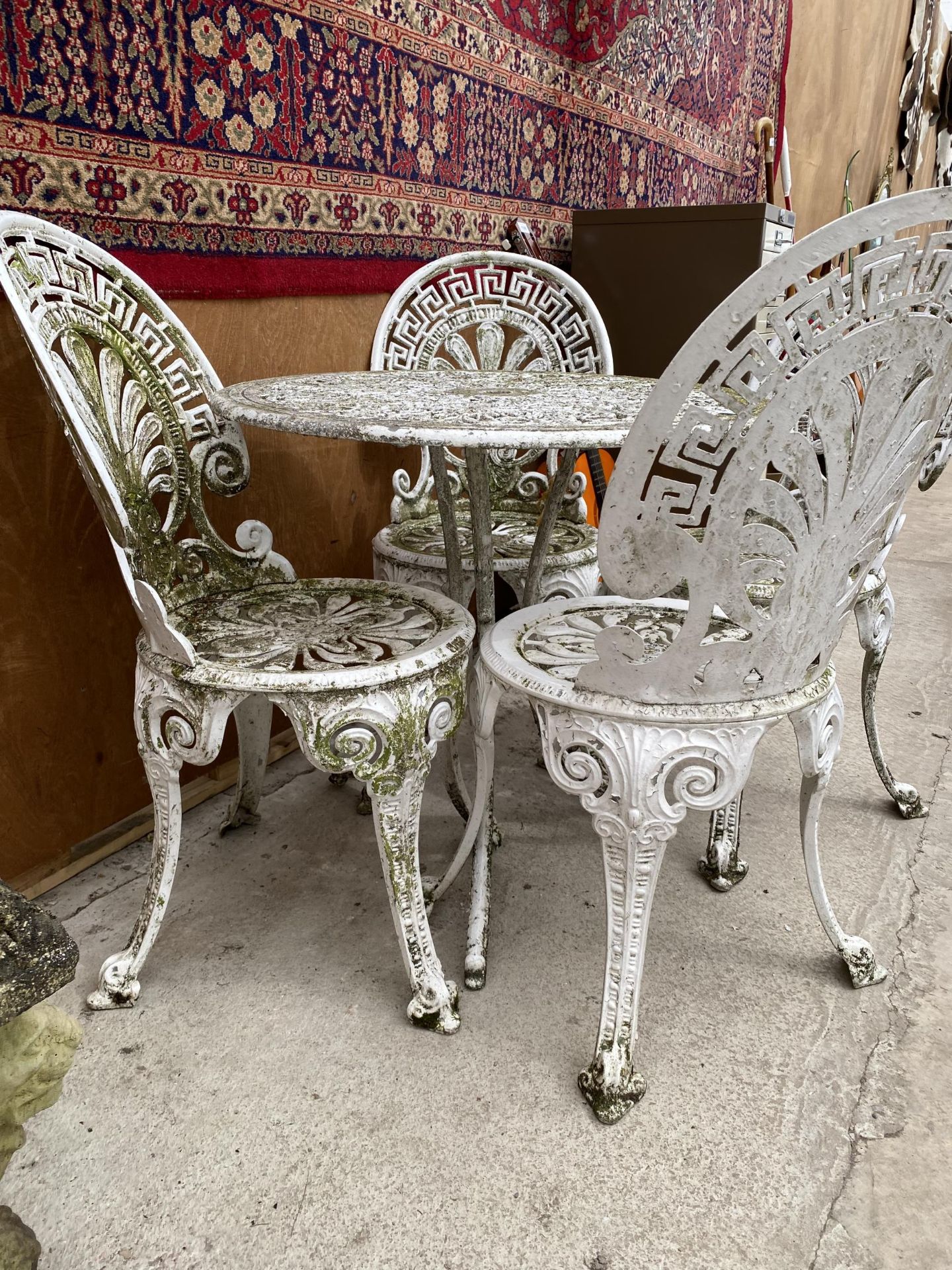 A WHITE VINTAGE CAST ALLOY BISTRO SET COMPRISING OF A ROUND TABLE AND FOUR CHAIRS - Image 2 of 3