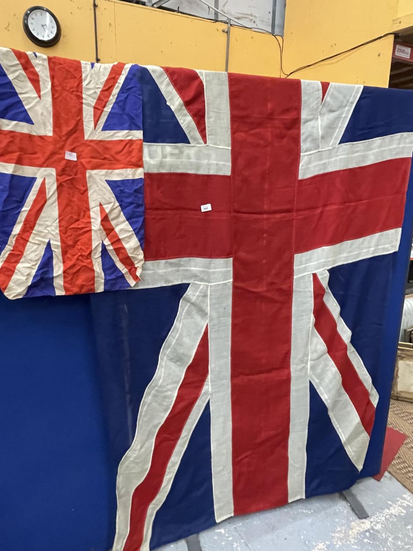 A LARGE HESSIAN UNION JACK, 150 X 267CM AND A SMALLER EXAMPLE