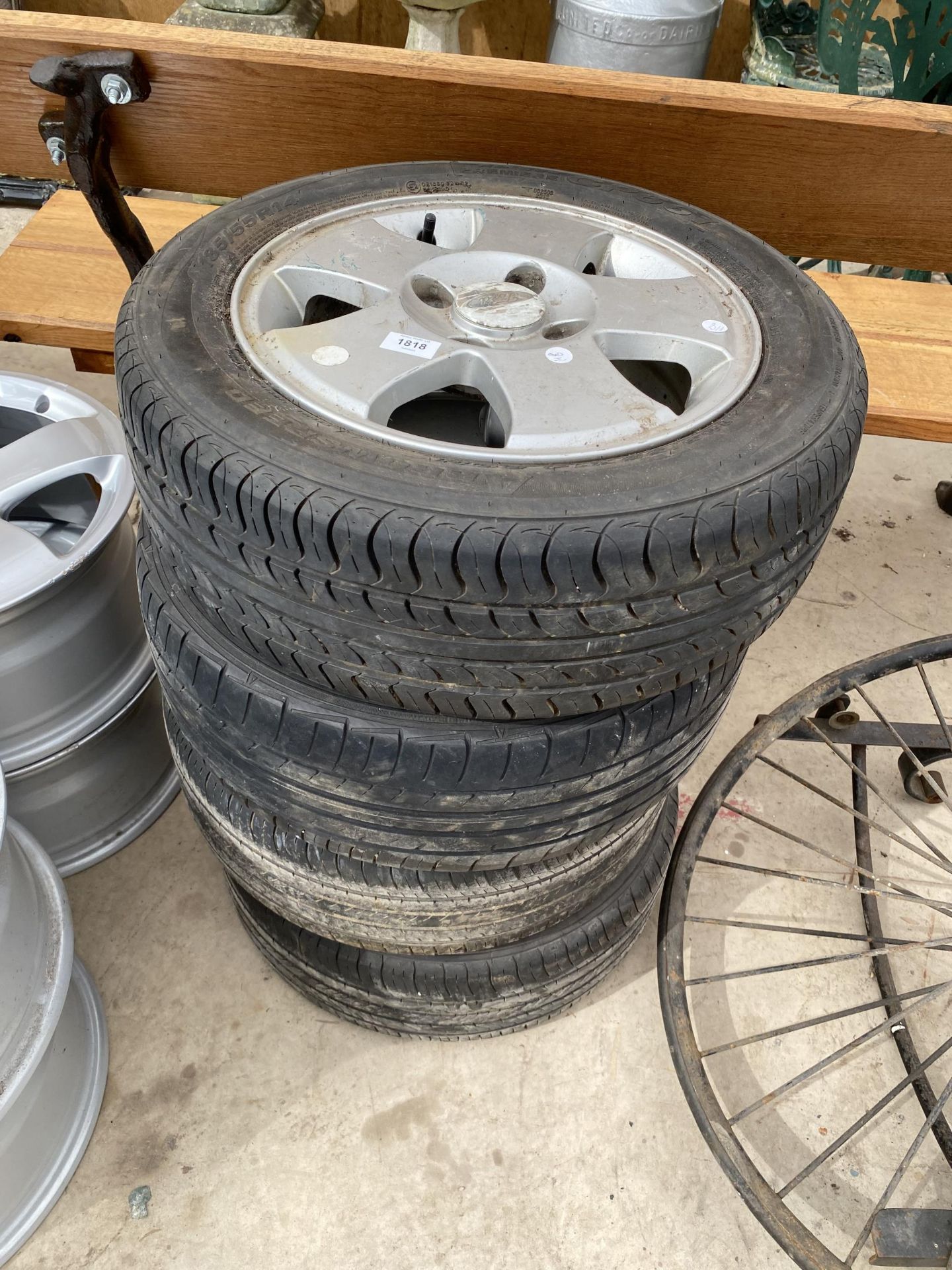 A SET OF FOUYR 'FORD RIMS WITH 185/55R14 TYRES