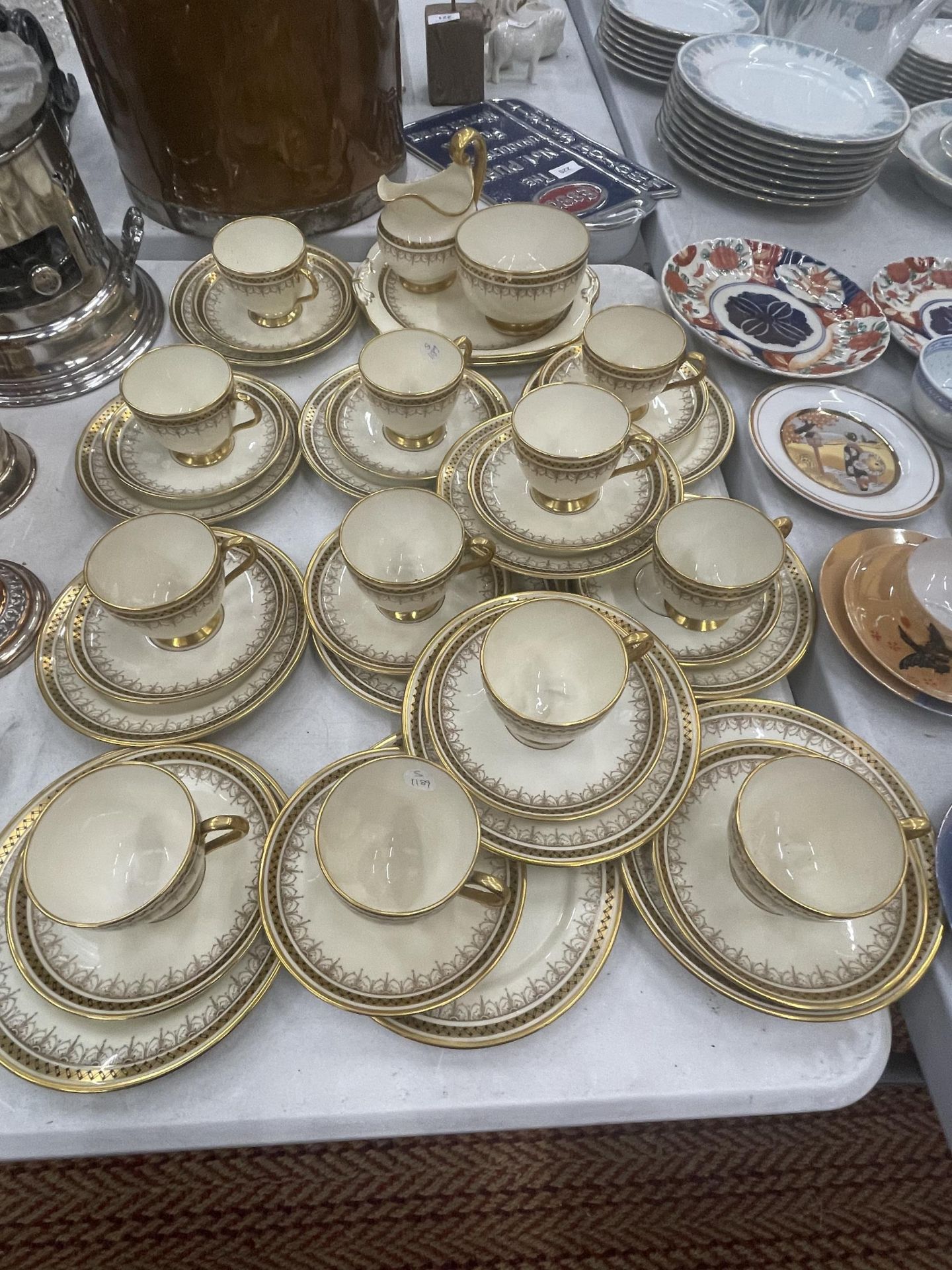 A LARGE GROSVENOR CHINA GILT DESIGN PART TEA SET MAINLY CONSISTING OF TRIOS