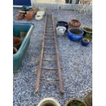 A VINTAGE WOODEN 18 RUNG LADDER