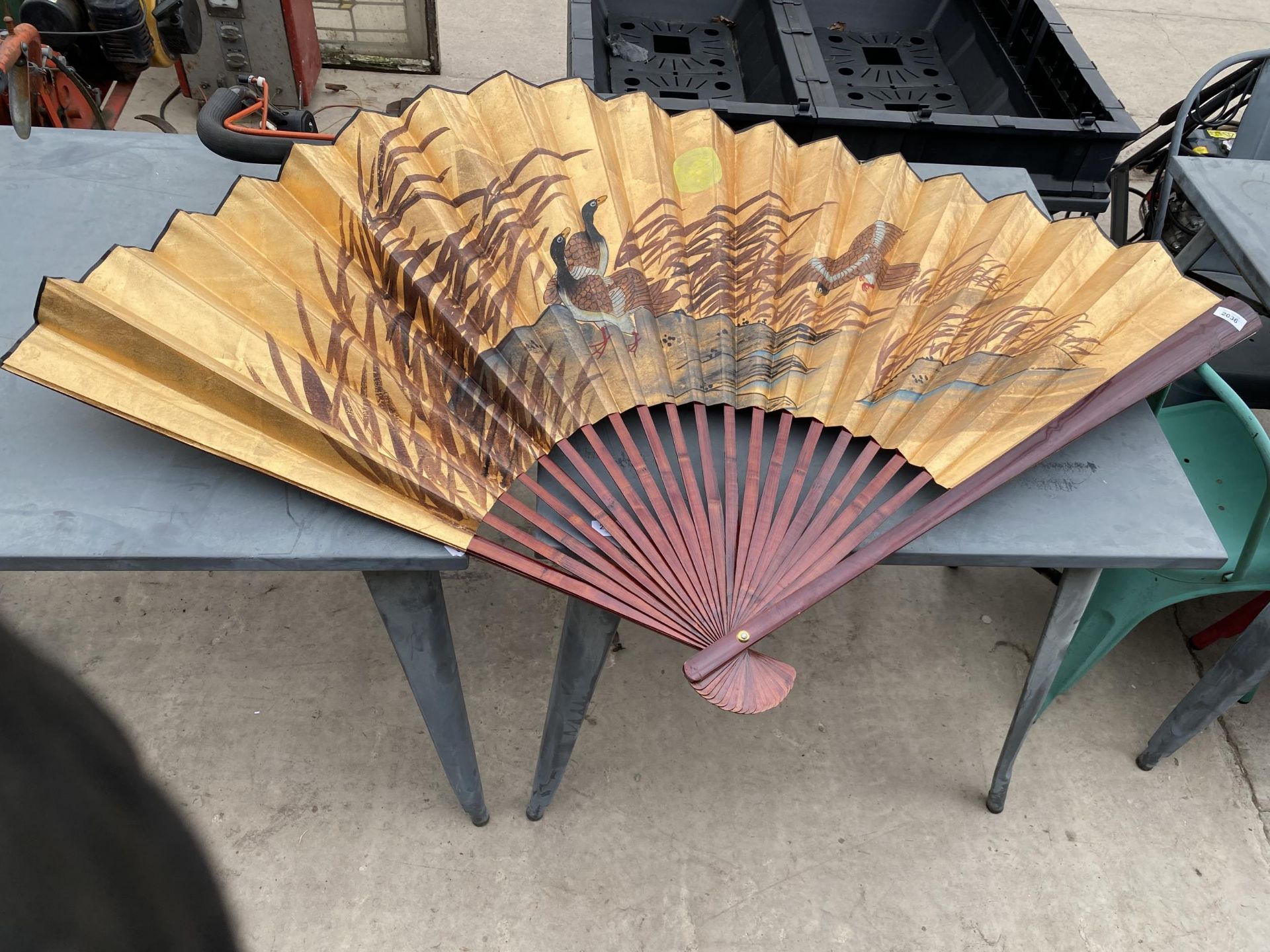 A LARGE ORIENTAL FOLDING FAN