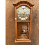 A WOODEN CASED WESTMINISTER CHIMING WALL CLOCK